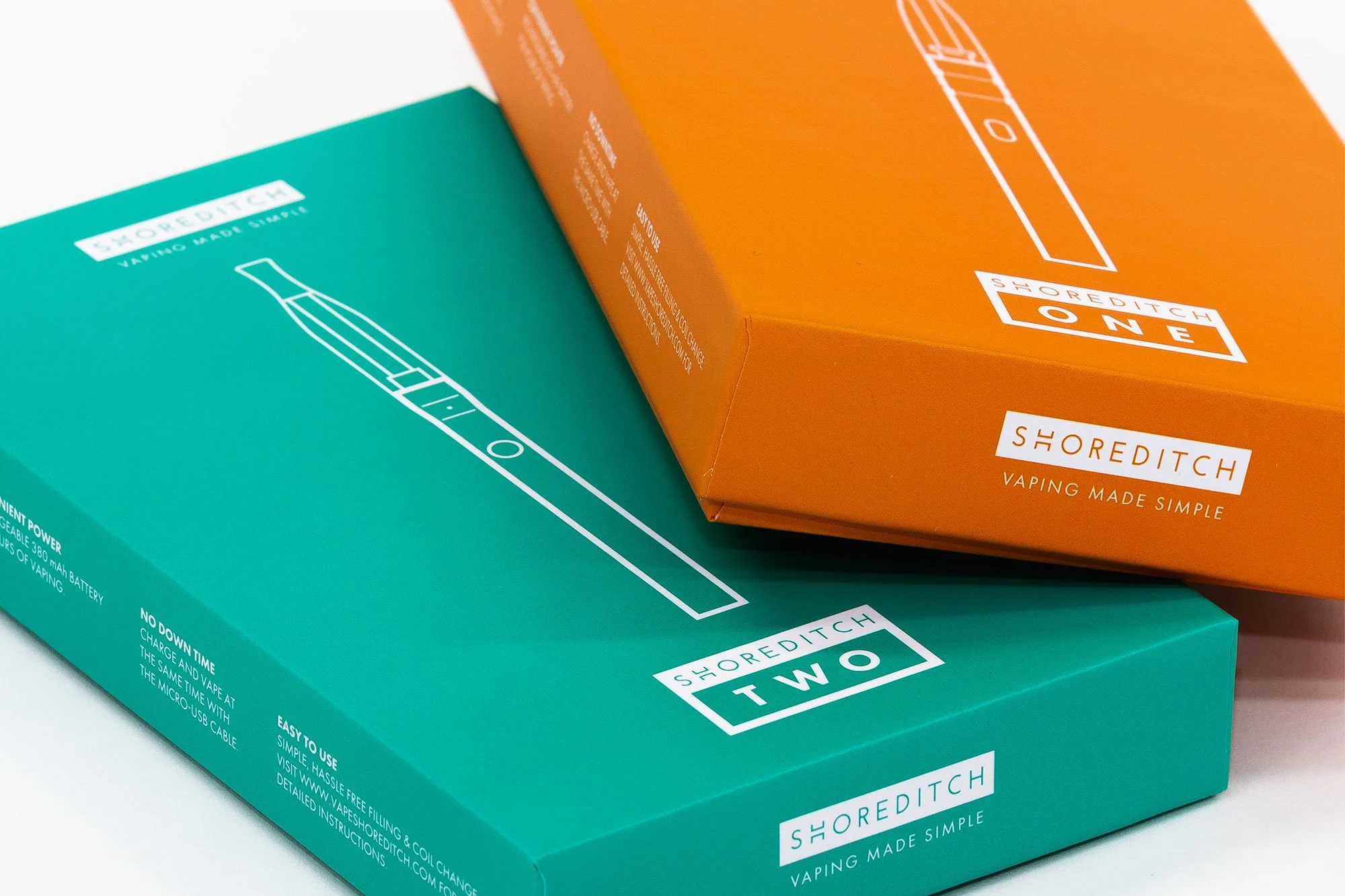 Close-up of teal and orange Shoreditch vaping product boxes with minimalistic line drawing of a vape device and the Shoreditch logo.