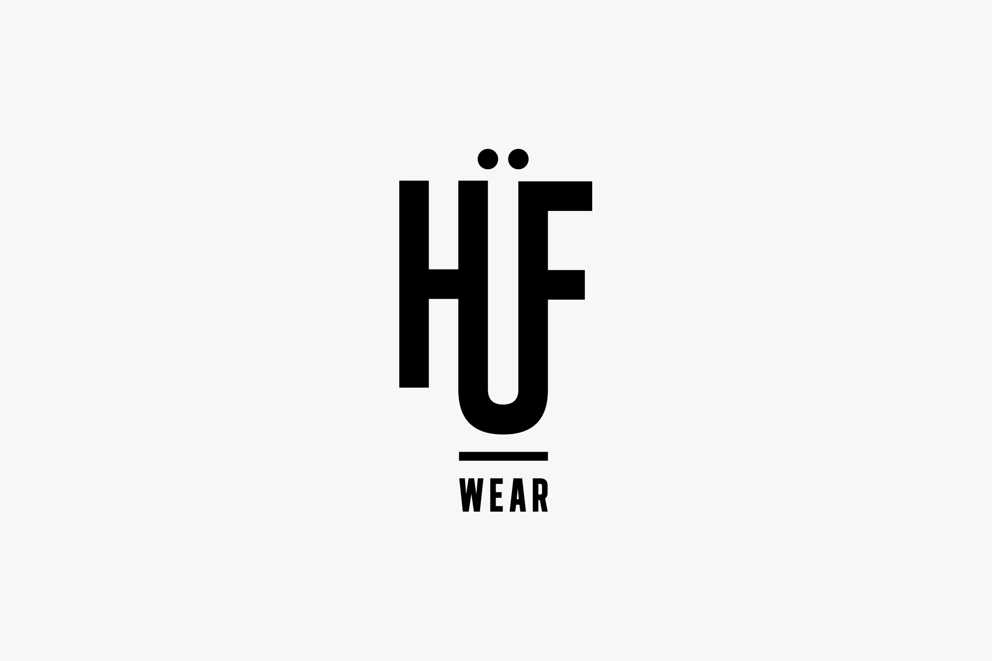 Text logo with the words 'HÜWEAR' in black font on a light gray background.