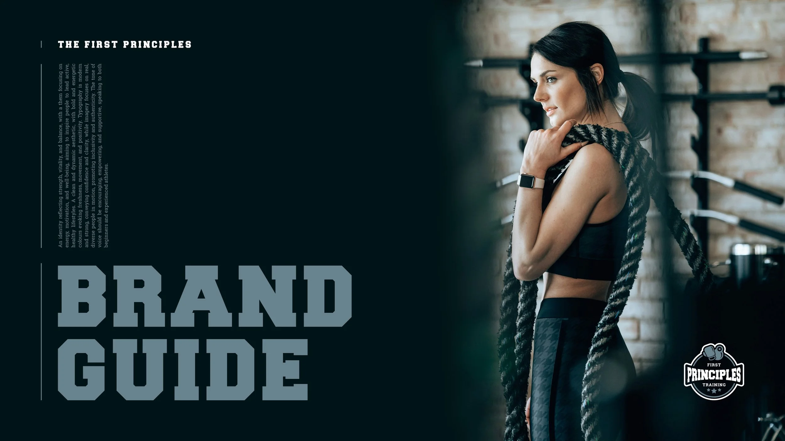 A woman with dark hair tied in a ponytail, wearing a smartwatch, black sports bra, and patterned workout leggings, standing in a gym with brick walls and hanging workout equipment, holding a thick rope over her shoulder.
