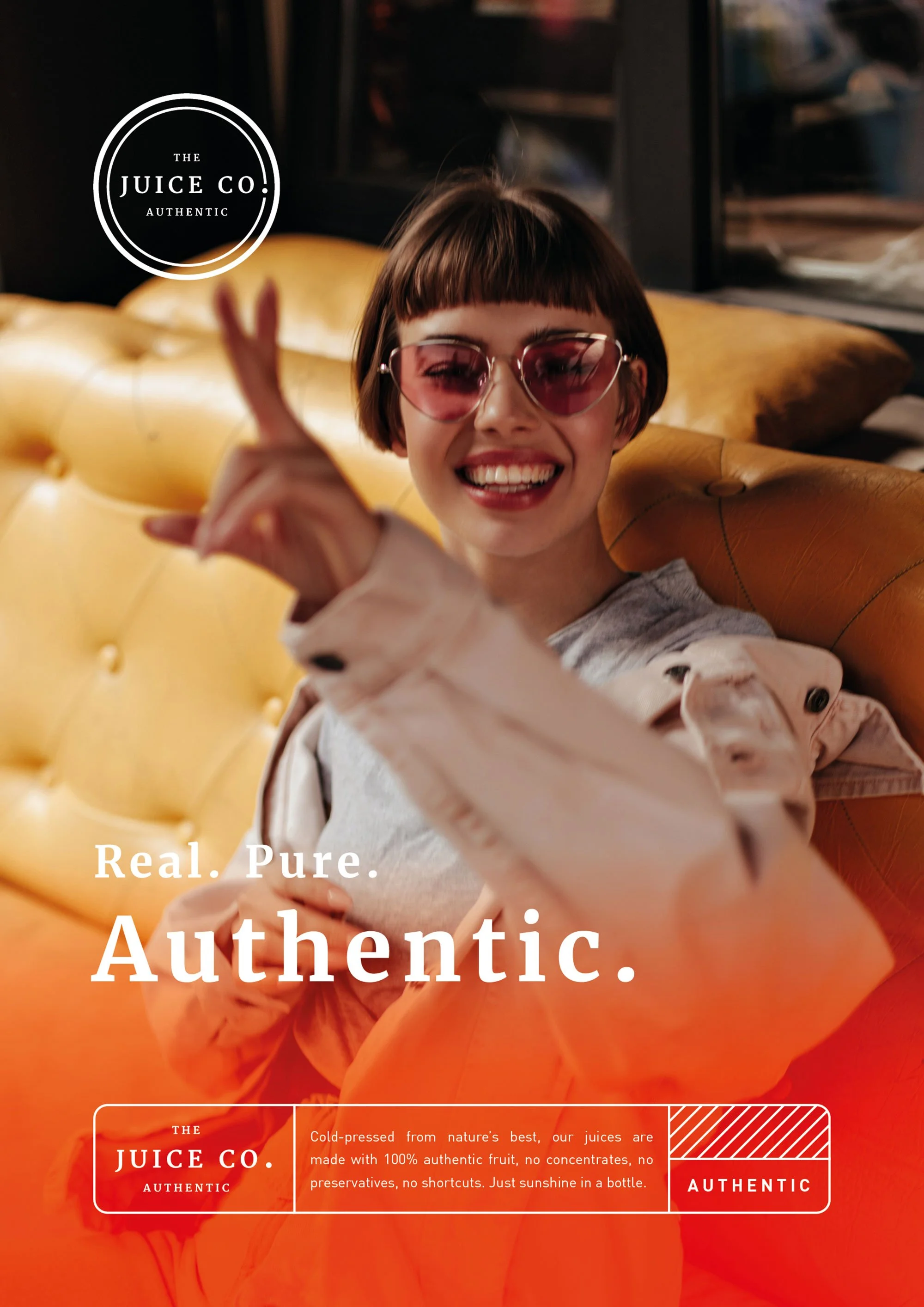 A woman with a short haircut and pink sunglasses smiling and making a peace sign with her fingers. She is sitting on a yellow sofa in a cozy interior setting. The image features overlaying text that reads 'Real. Pure. Authentic.' and branding from 'T