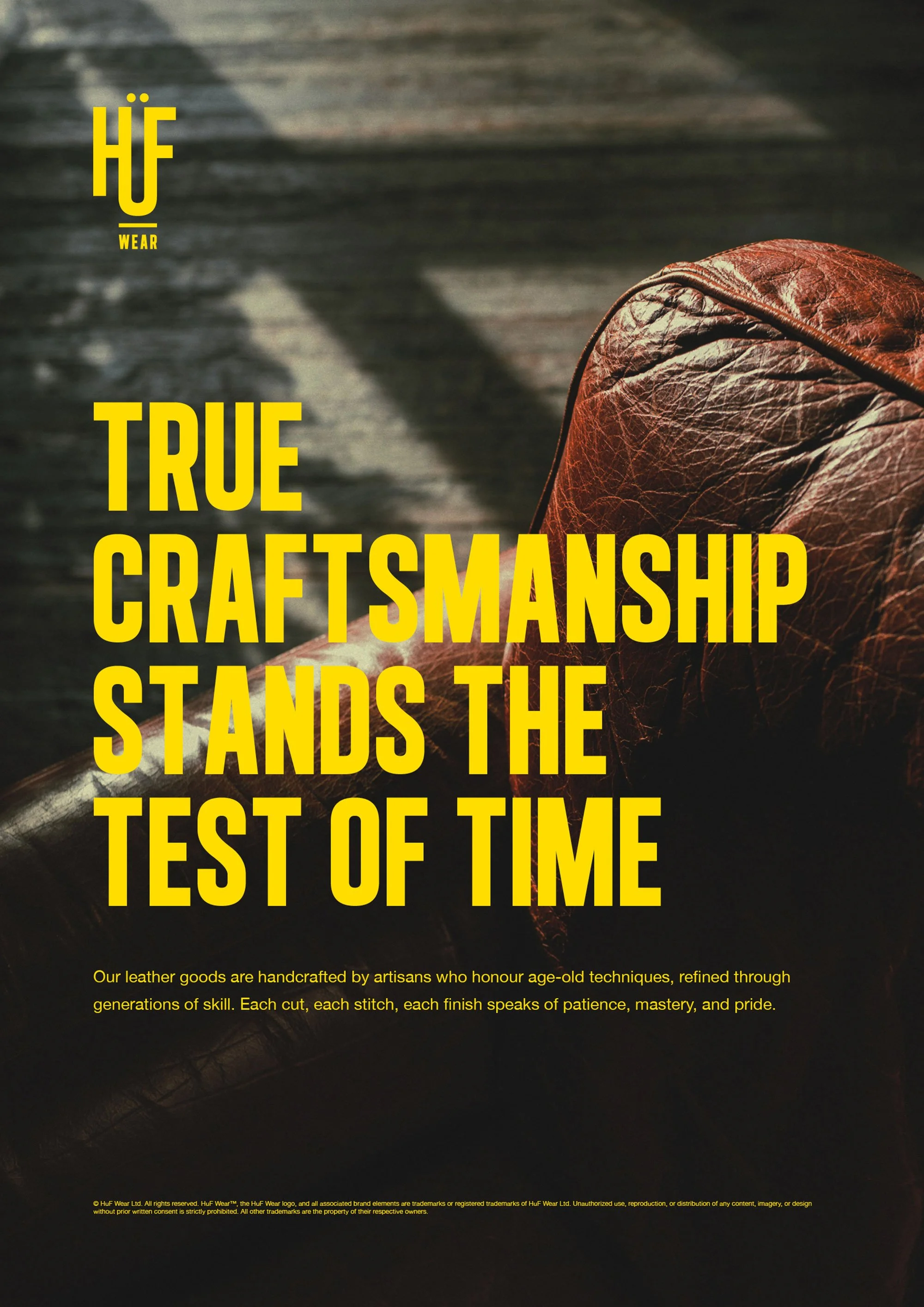 Close-up of a brown leather strap on a quality crafted item, with bold yellow text overlay that reads 'HÜWEAR TRUE CRAFTSMANSHIP STANDS THE TEST OF TIME'. Smaller yellow text below describes handcrafted leather goods by artisans.