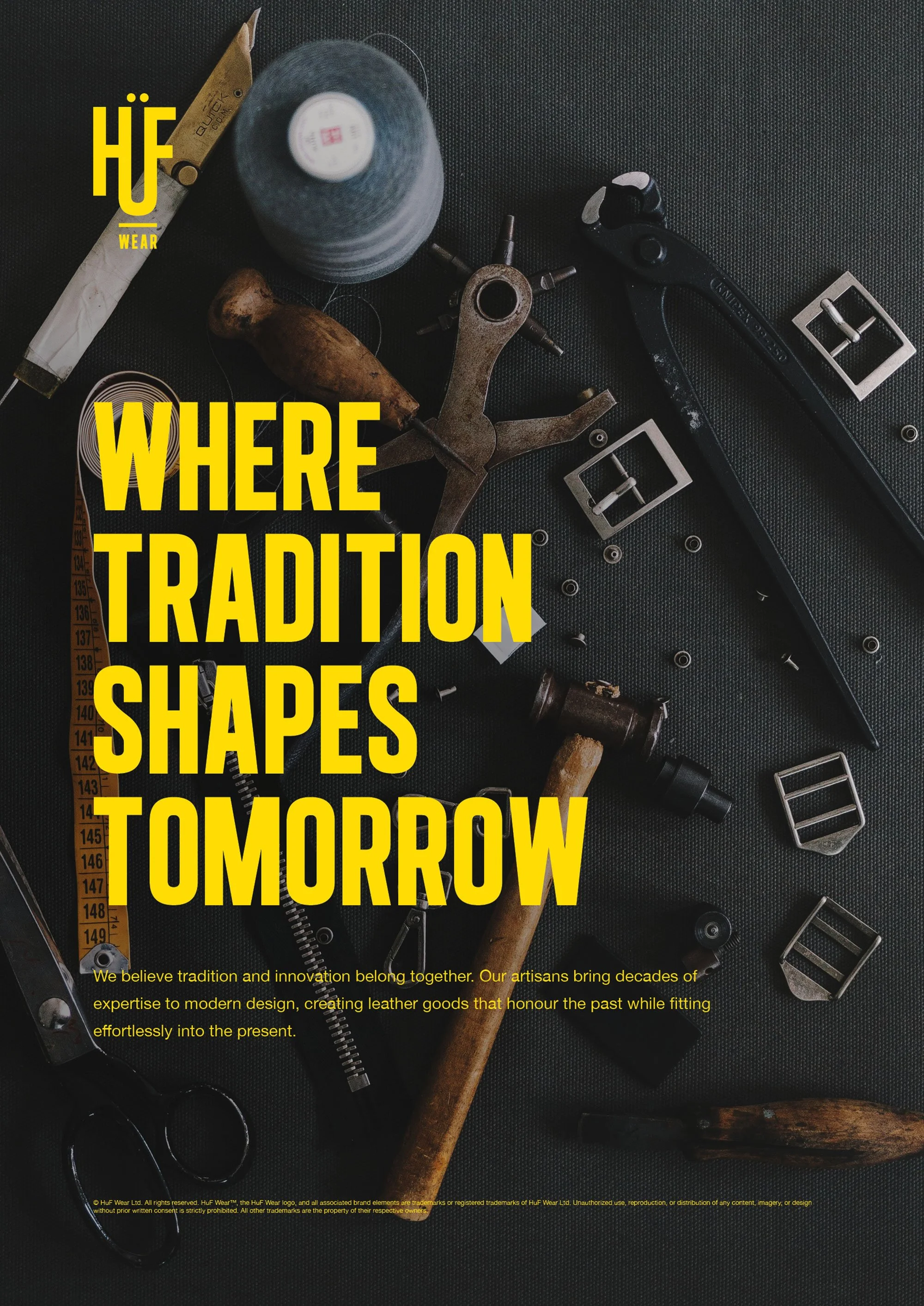 A flat lay of various leatherworking tools, including a measuring tape, hammer, leather punch, buckle, and other hardware parts on a black textured surface. Overlaid yellow text reads 'HUE WEAR WHERE TRADITION SHAPES TOMORROW' with a smaller paragrap