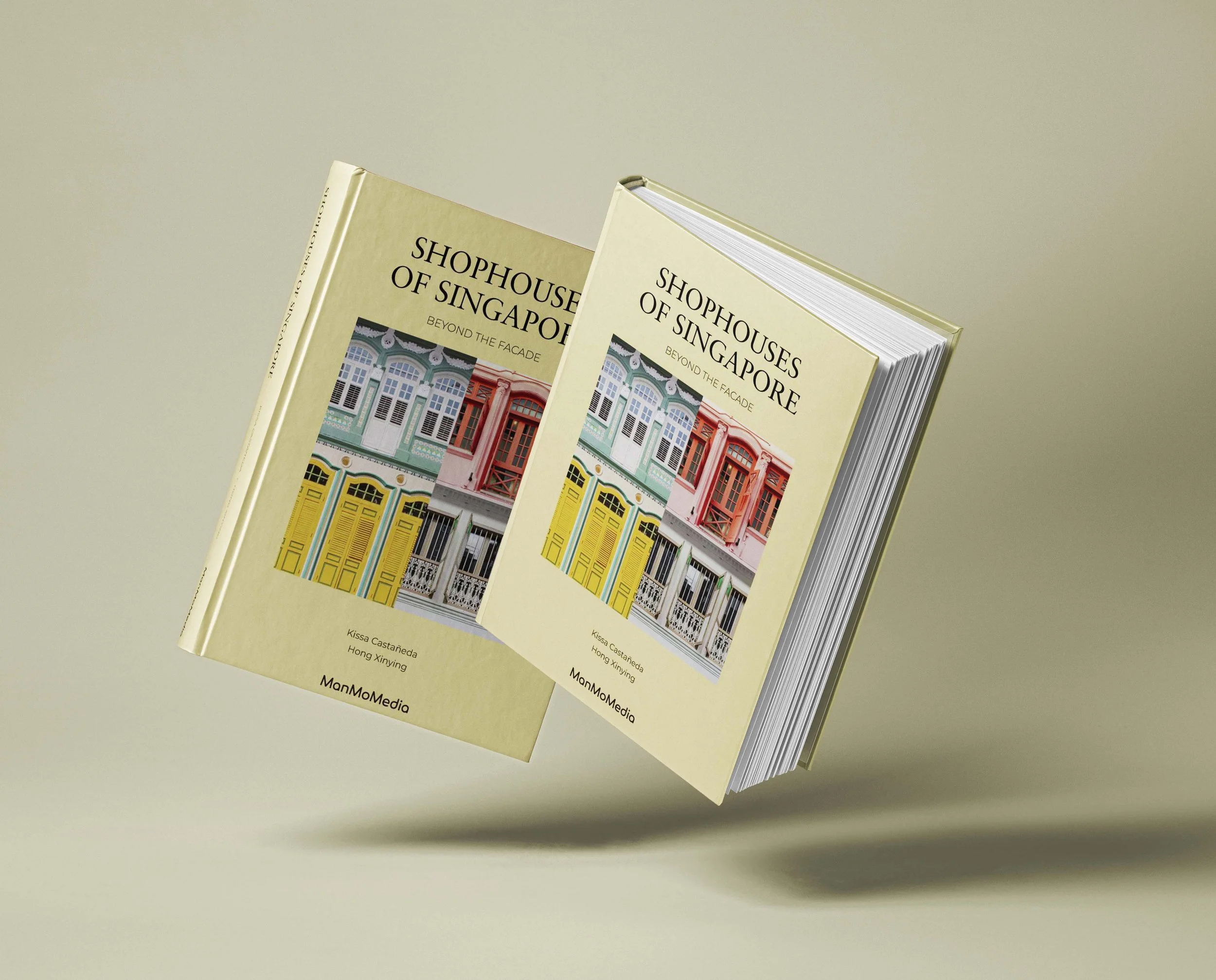 A brochure or book titled 'Shophouses of Singapore: Beyond the Facade' with a colorful illustration of shophouses on the cover, placed on a light surface.