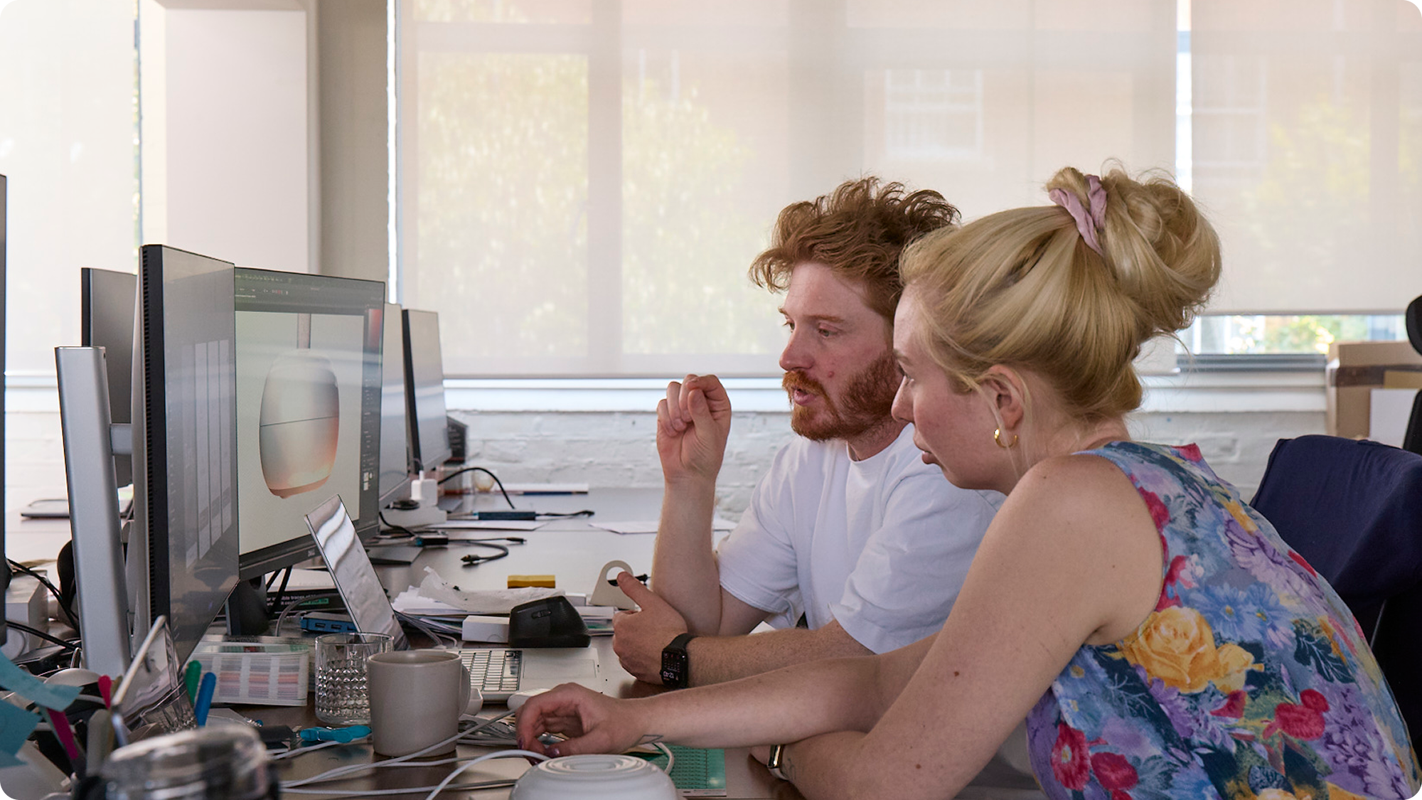 Tom Glover and Madee Higson working together in an office