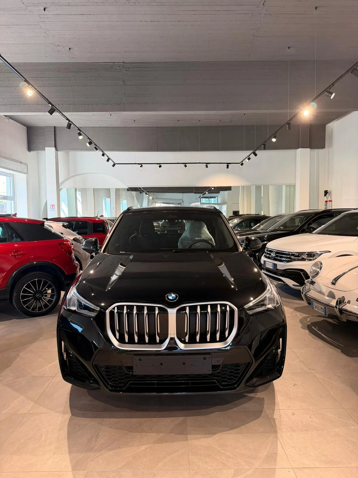 Auto BMW nera in primo piano in showroom 