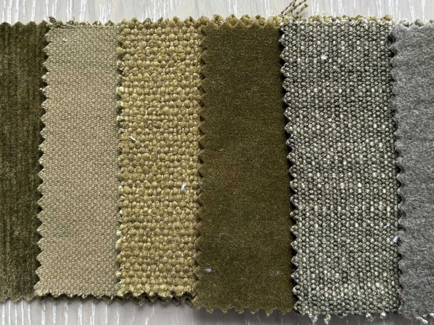 Earth-toned interior design fabric samples showing a natural palette with varied textures and woven finishes