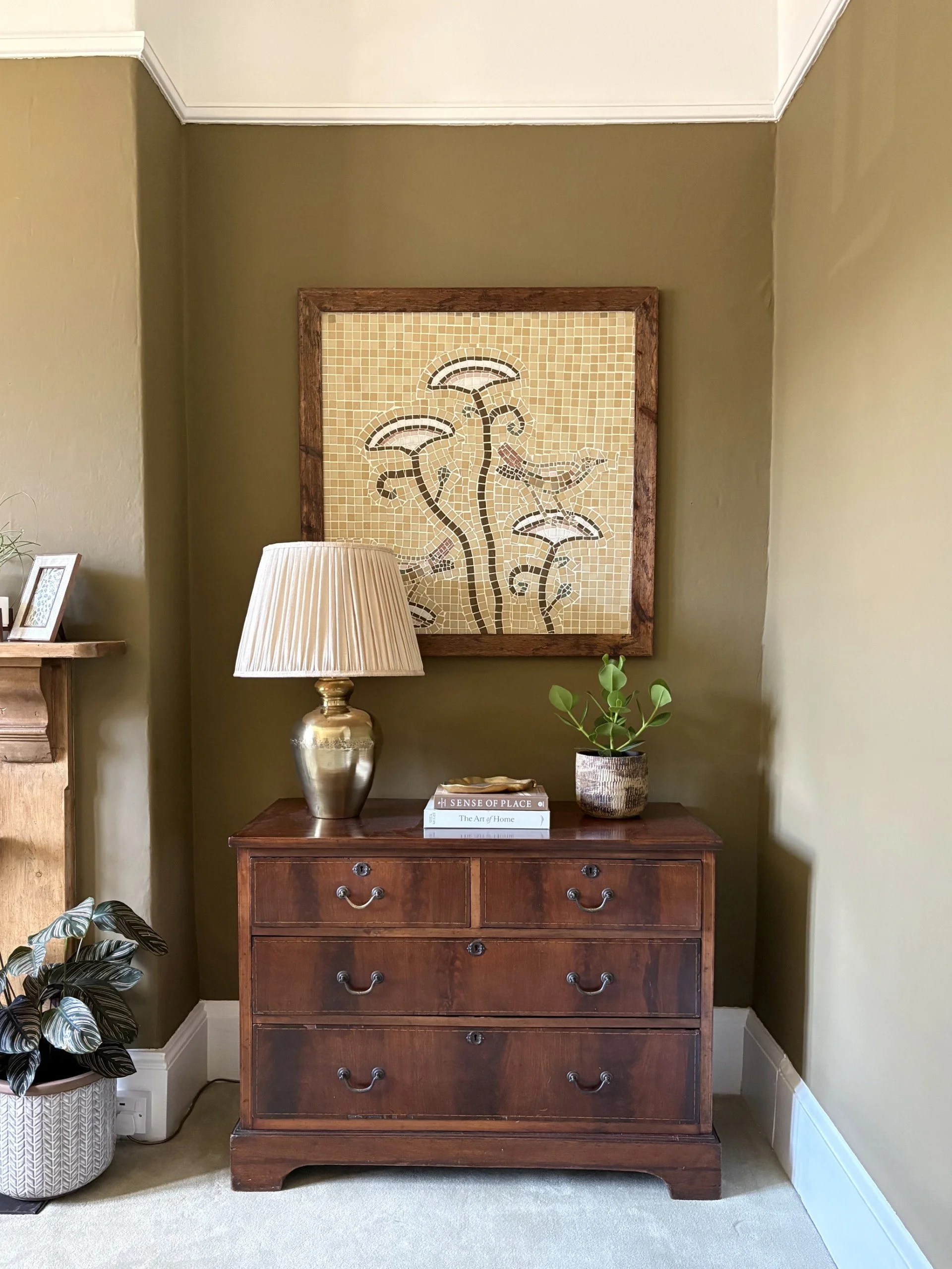 Layered interior vignette blending antique furniture, contemporary styling, rich texture and character in a period room