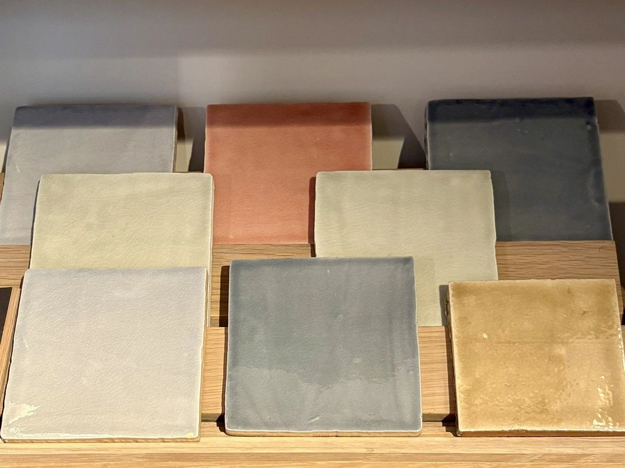 Interior design tile samples in a muted palette with softly mottled, painterly washes of colour and tonal variation