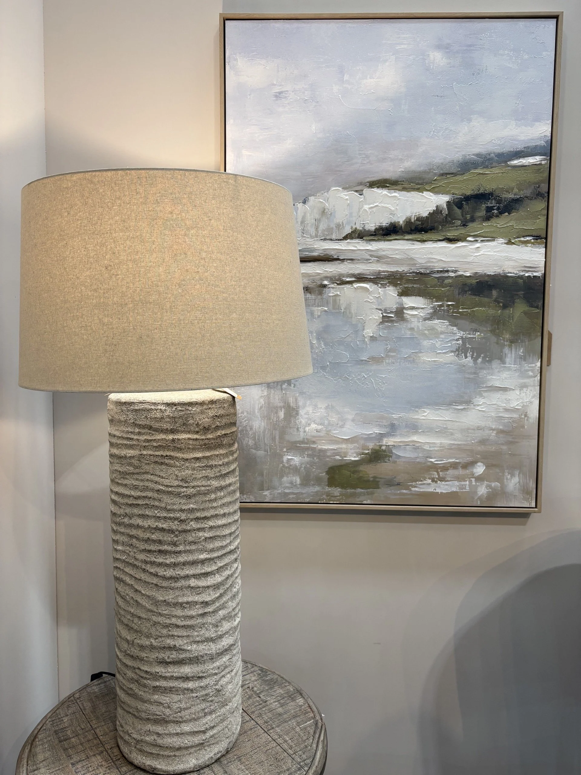 Textured table lamp and abstract artwork layered together in cool, cohesive tones, highlighting contrast between texture and pattern
