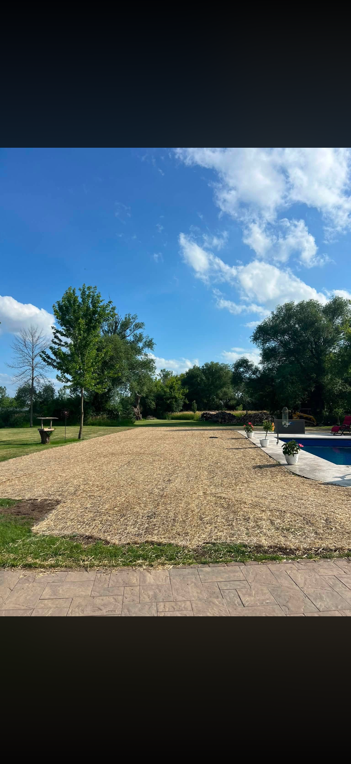 Topsoil Delivered and graded after a pool installation in Omro Wisconsin. Hay laid and grass planted.