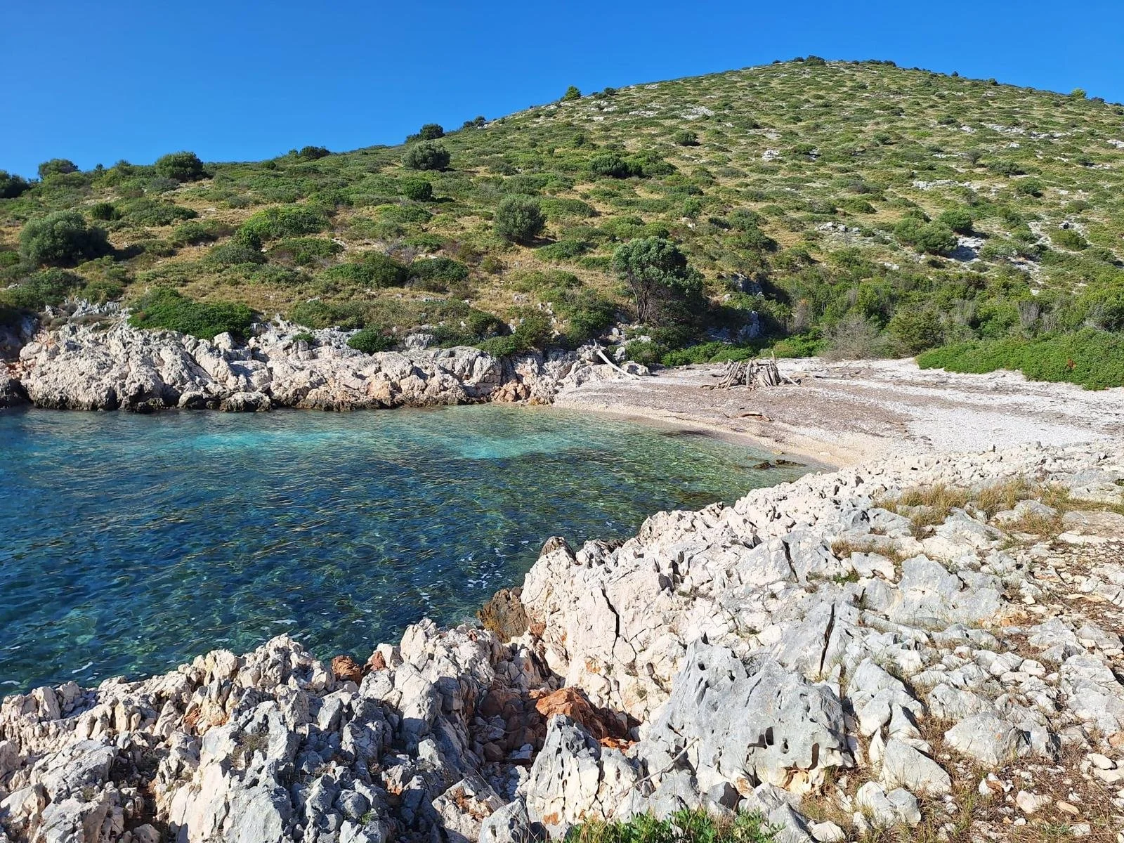 Adriatic beach with natural shoreline, clear water, and coastal landscape.