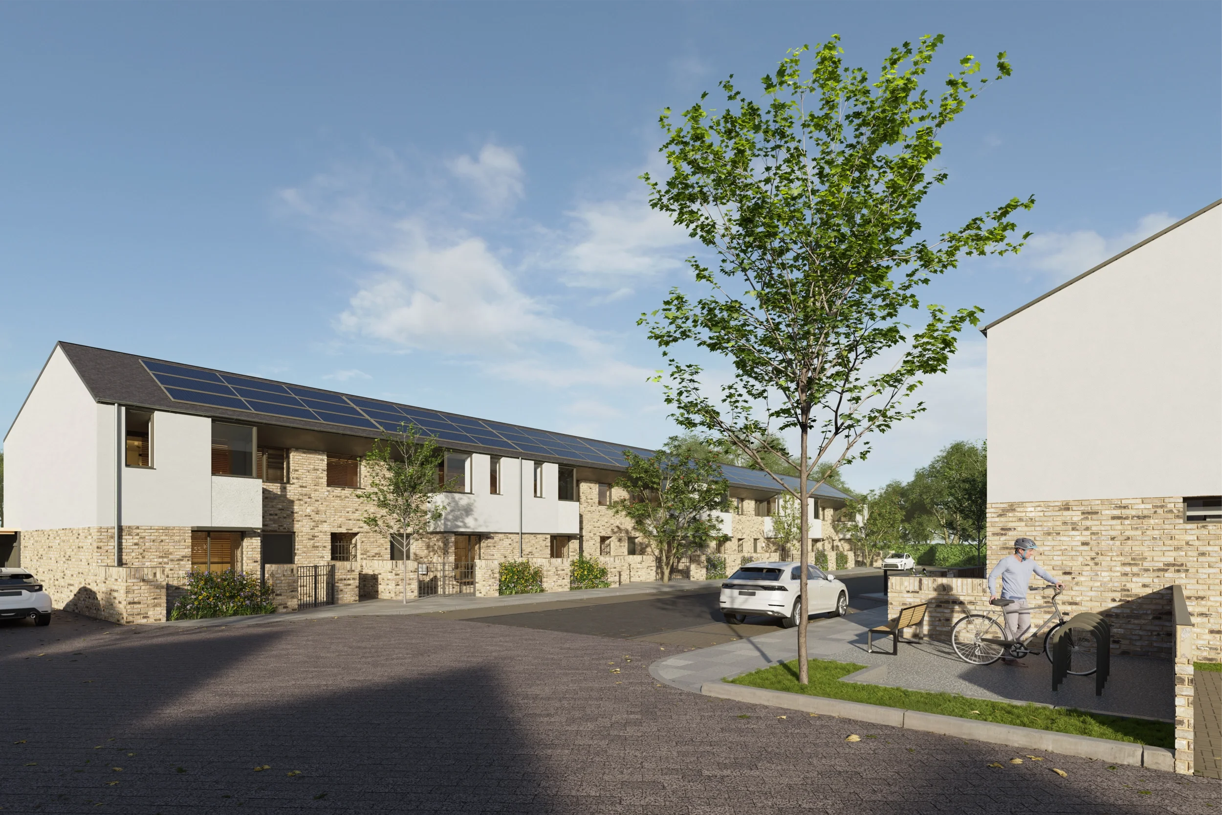 Levitate Architects FLEC Leicester modern terraced housing with solar panels, brick base, white render top, paved street, and bicycle parking.