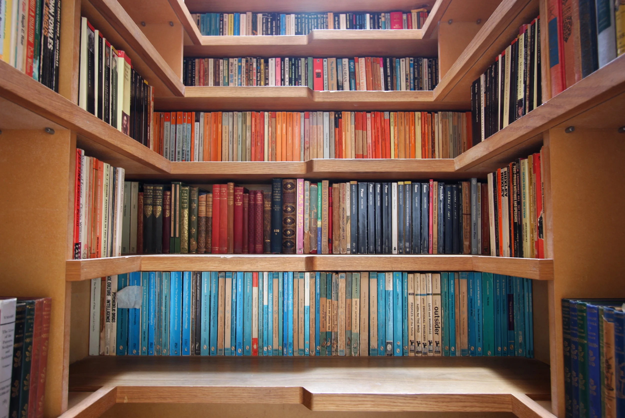Levitate's Bookcase Staircase elevation view showing oak treads and shelves stacked with an extensive book collection