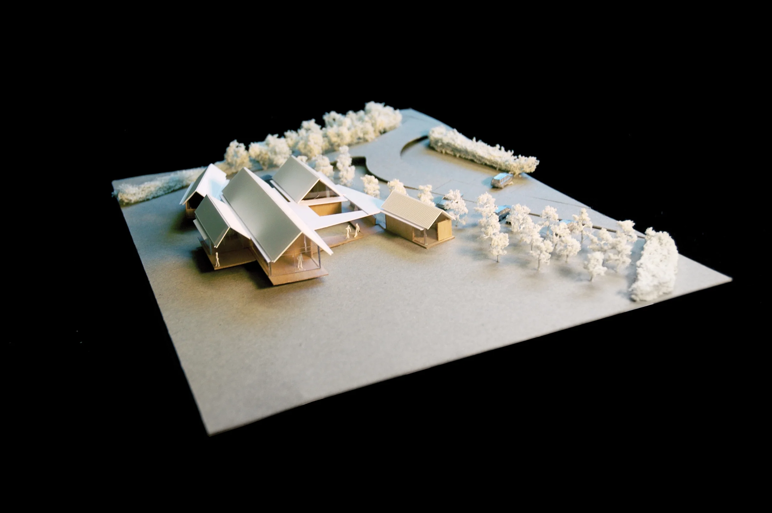 Levitate's Otter Valley Dairy Cafe architectural model showing four clustered volumes around a courtyard in the contoured landscape.
