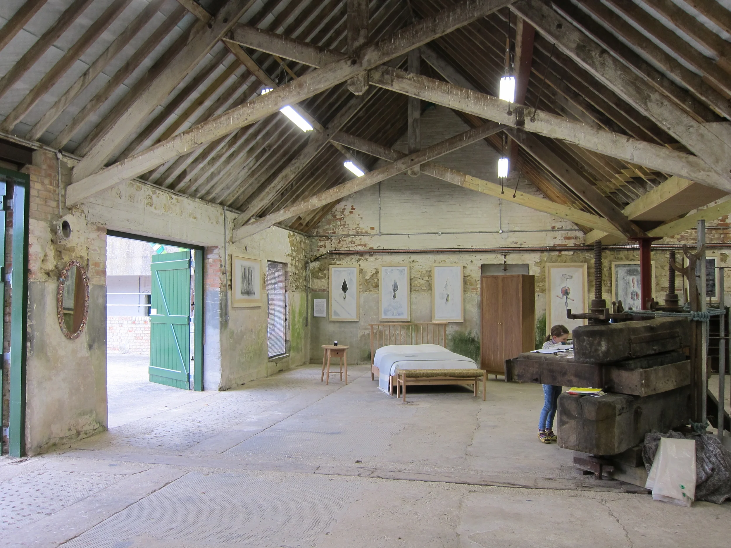 Levitate's Barrington Court barn interior with exposed timber roof trusses used as an exhibition and gallery space