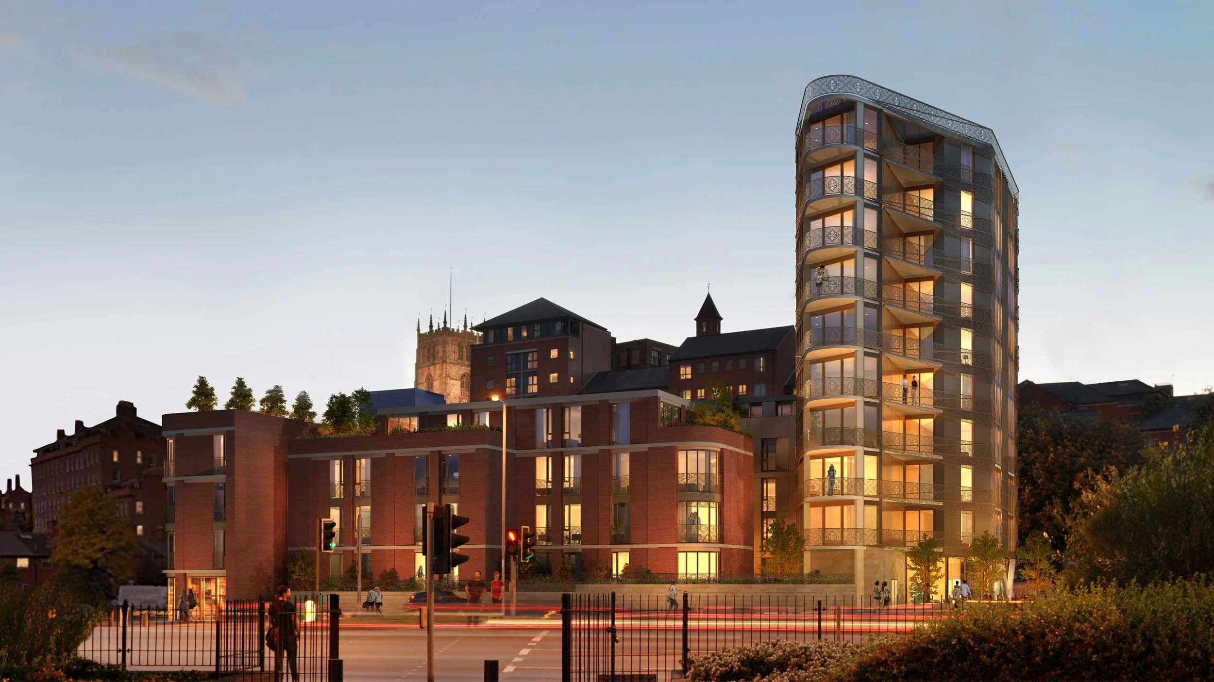 Levitate's Lace Building evening view showing interior lights glowing through the brick facade and intricate metal lace screening