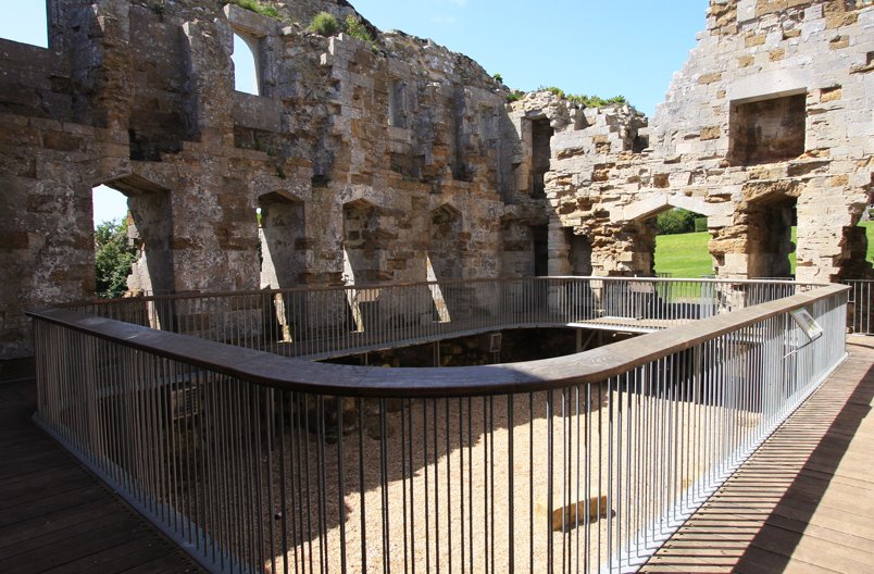 Award Winning Levitate Architects' Sandsfoot interior features a curved wood handrail, structuring a safe path through old castle walls.