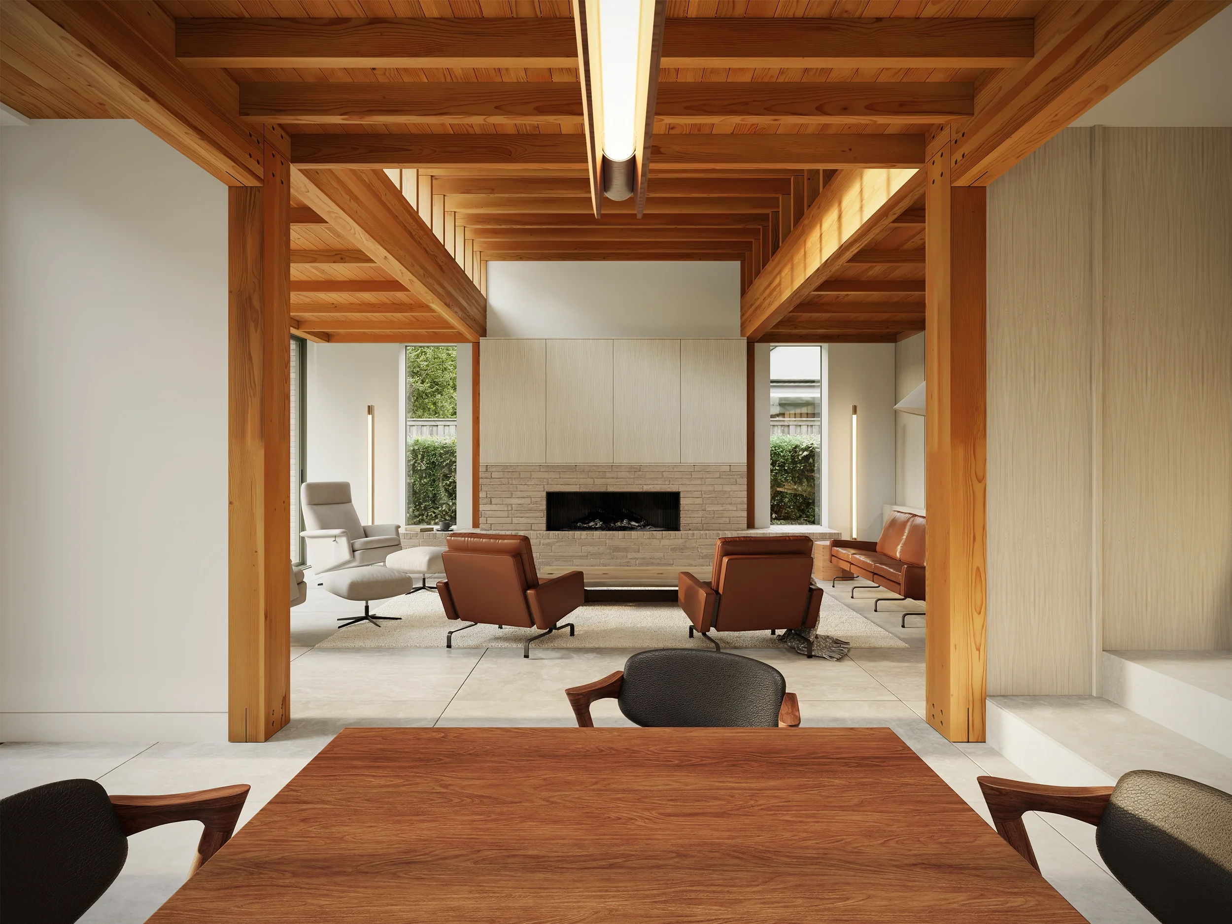 Levitate's new build home Adel, Leeds. An open-plan dining space looking into a living area with a stone fireplace and exposed timber structure.