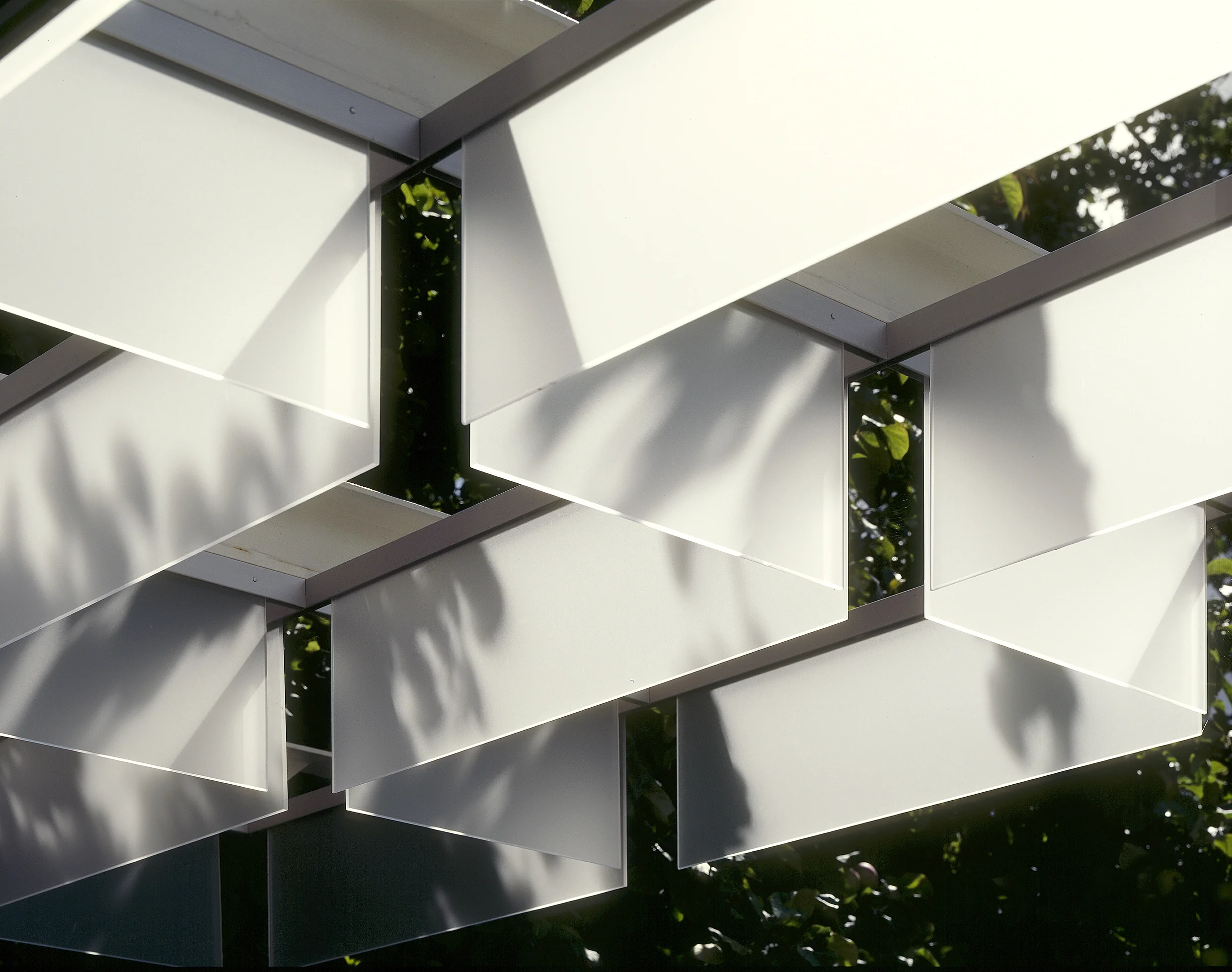 Levitate's wandsworth house detail of the glass fin canopy filtering light and connecting the home to the garden's edge.
