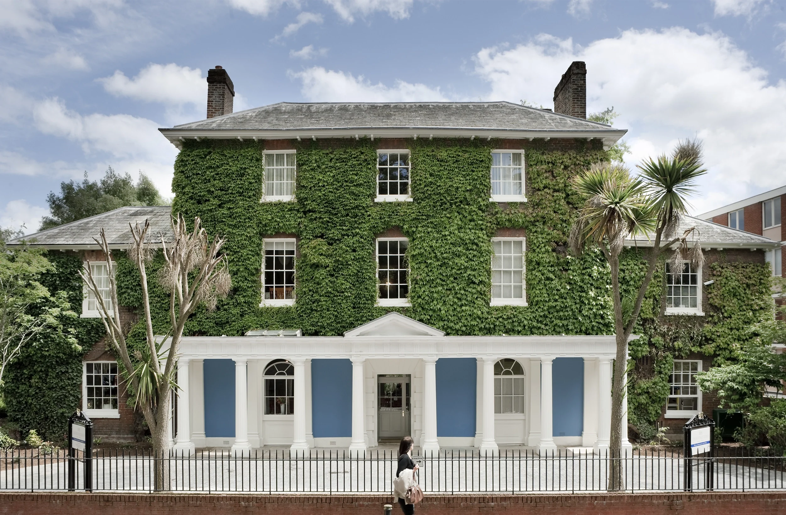 Levitate's Southernhay Hotel Georgian facade covered in ivy with a blue and white colonnaded veranda entrance