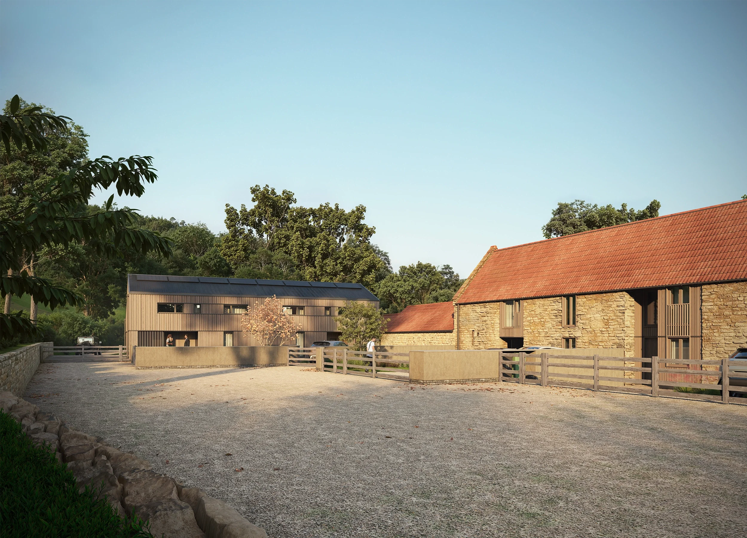 Levitate's Newton Farm Barns gravel driveway entrance highlighting the restored Grade II listed stone barn with a traditional terracotta tile roof
