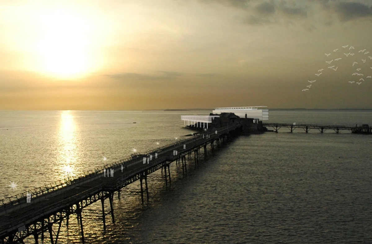 Levitate's Birnbeck pier sunset visualization of the restored Grade II Listed pier with new buildings, showing a heritage conservation approach.