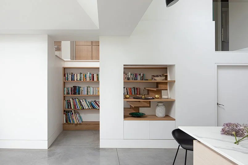 Levitate Architects Gloucester Drive modern interior extension with built‑in shelving, reading nook, and minimalist detailing in oak and white.