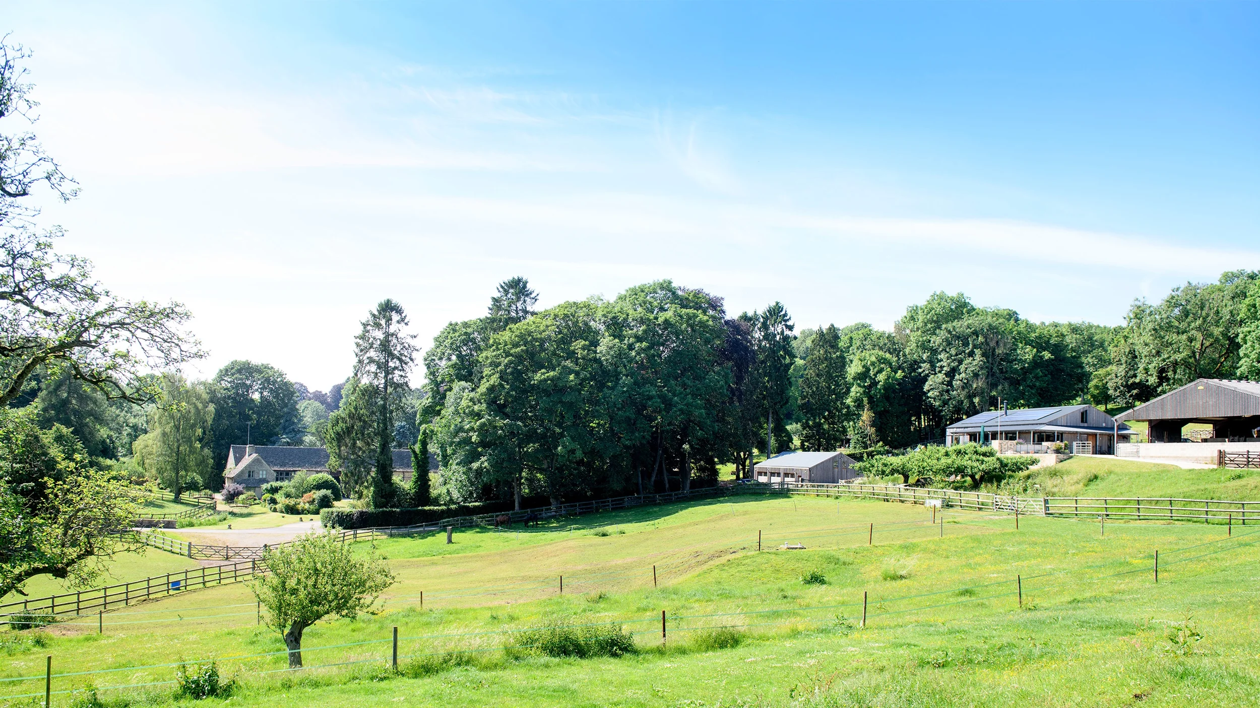 Levitate Architects Dairy Shed farm setting within the Cotswolds landscape, illustrating adaptive reuse and low carbon design principles in rural context.