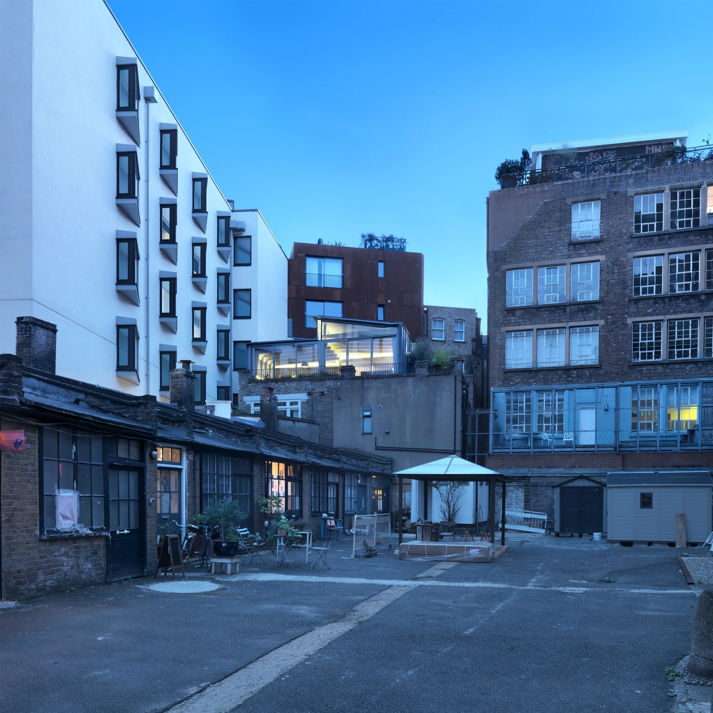 Levitate's London Shoreditch Loft courtyard view showing the metal clad, timber and glass extension nestled among surrounding rooftops