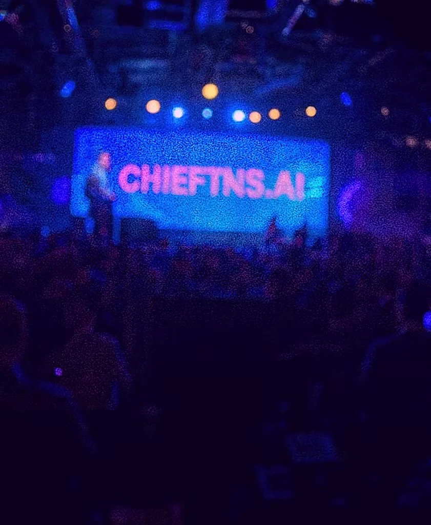 A photo of Chieftns.ai presenting on stage at a conference
