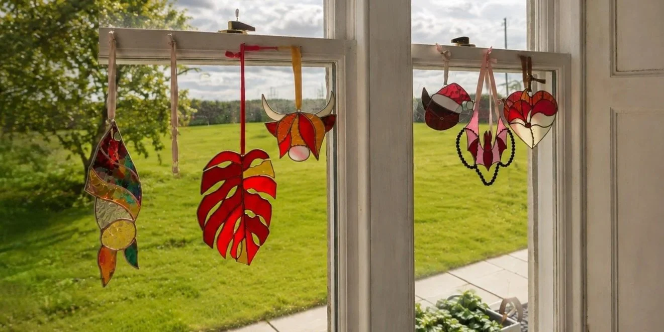 Beautiful stained glass suncatchers displayed in the summer light