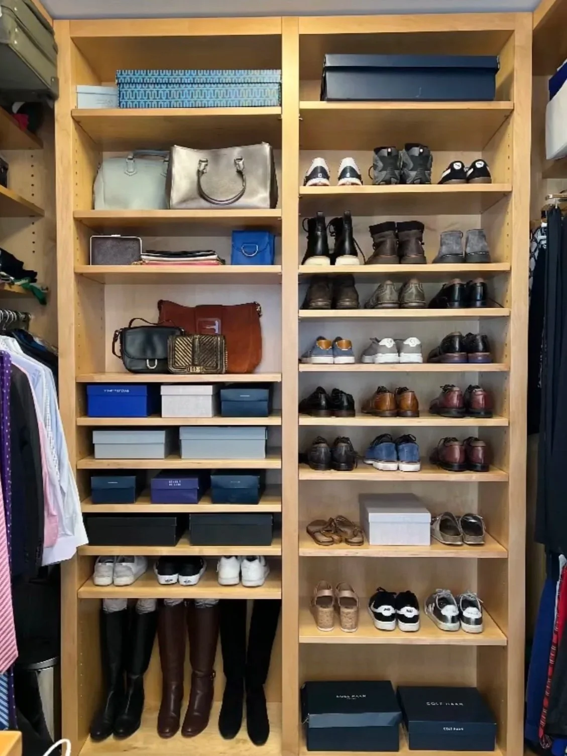 Wooden shelving unit filled with various handbags, shoes, and boxes in a retail store.