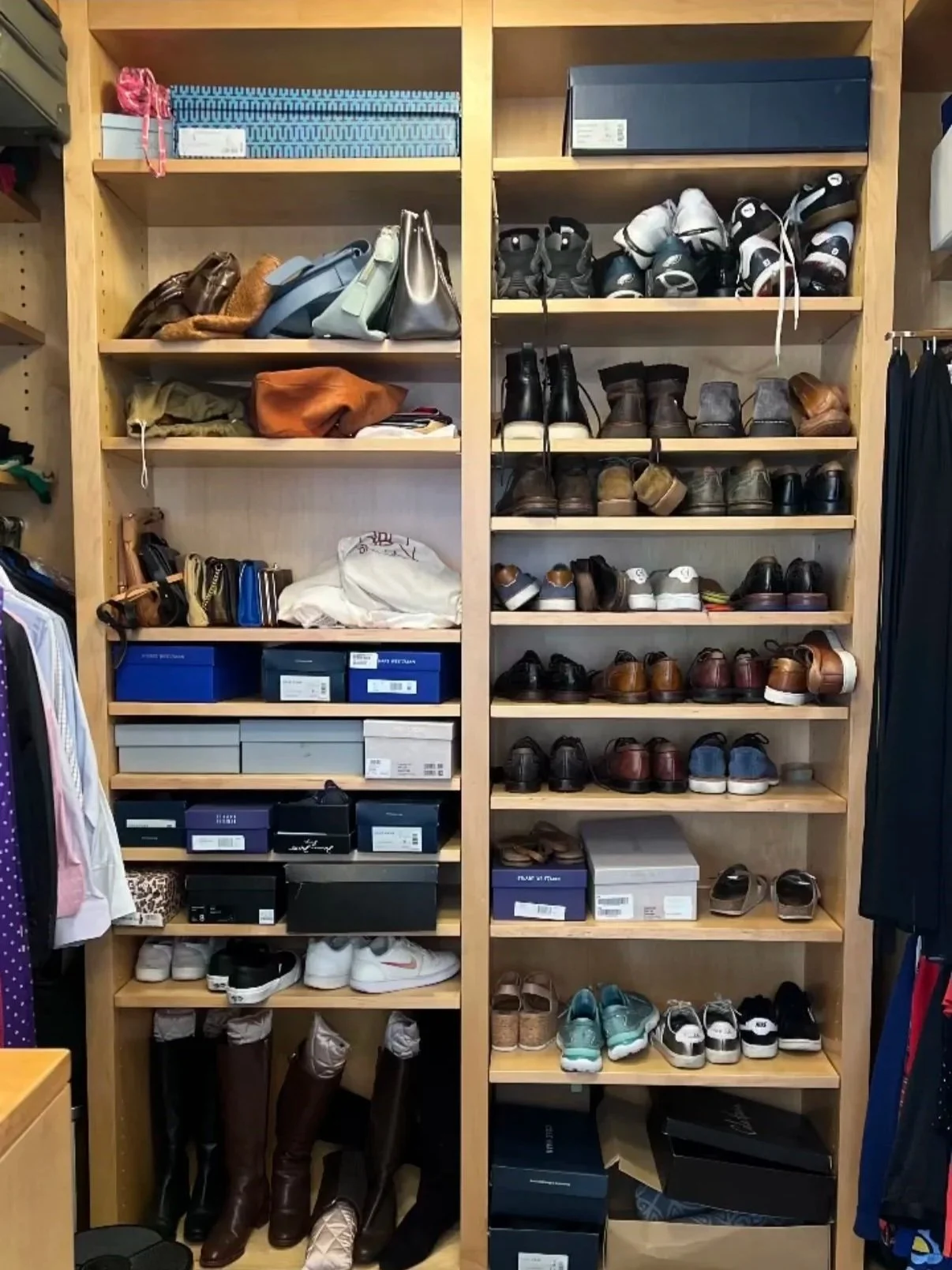 Wooden shelving unit filled with handbags, shoes, and shoeboxes in a closet or retail store.