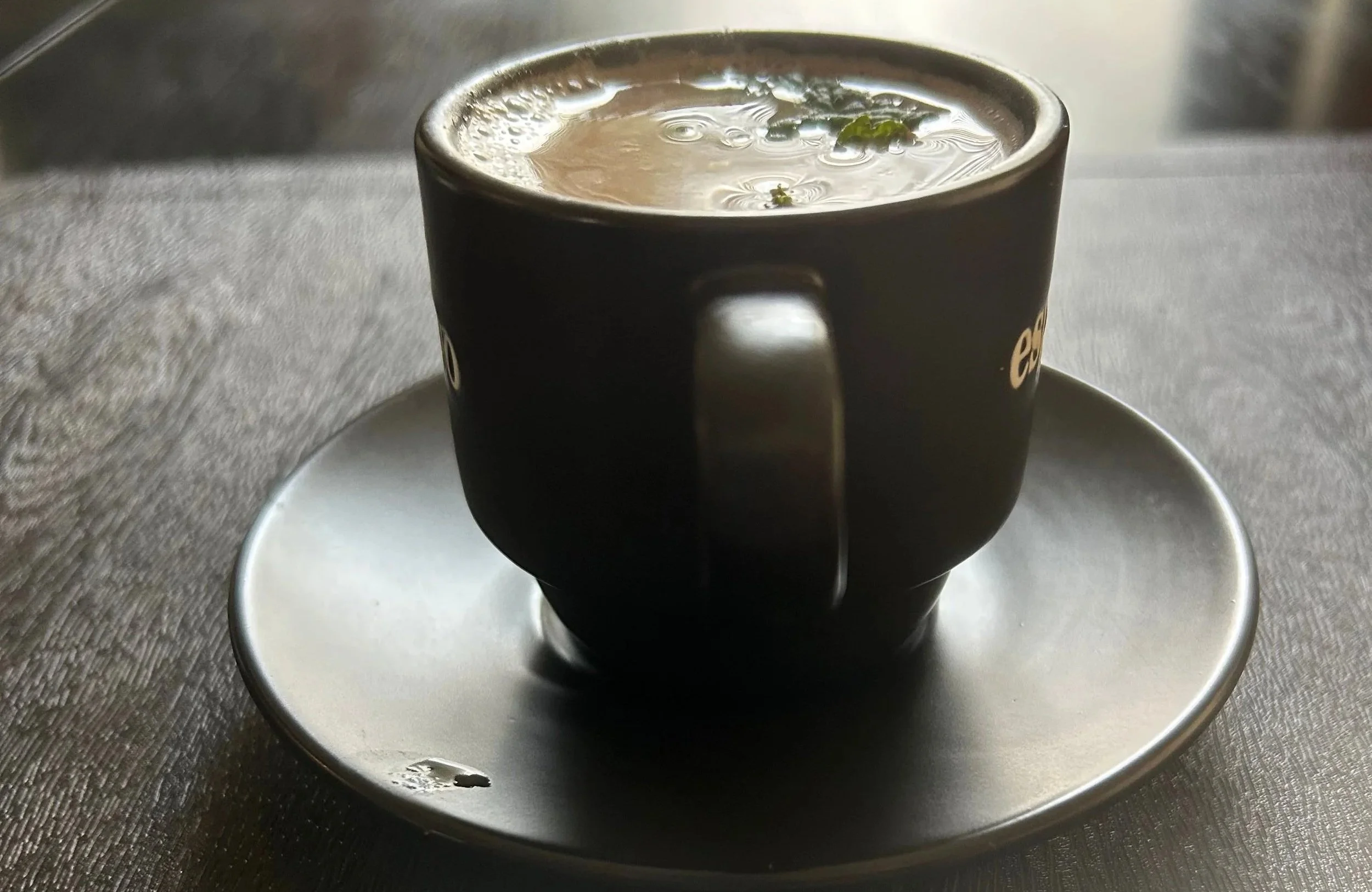 steaming cup of traditional masala chai served in ceramic mug