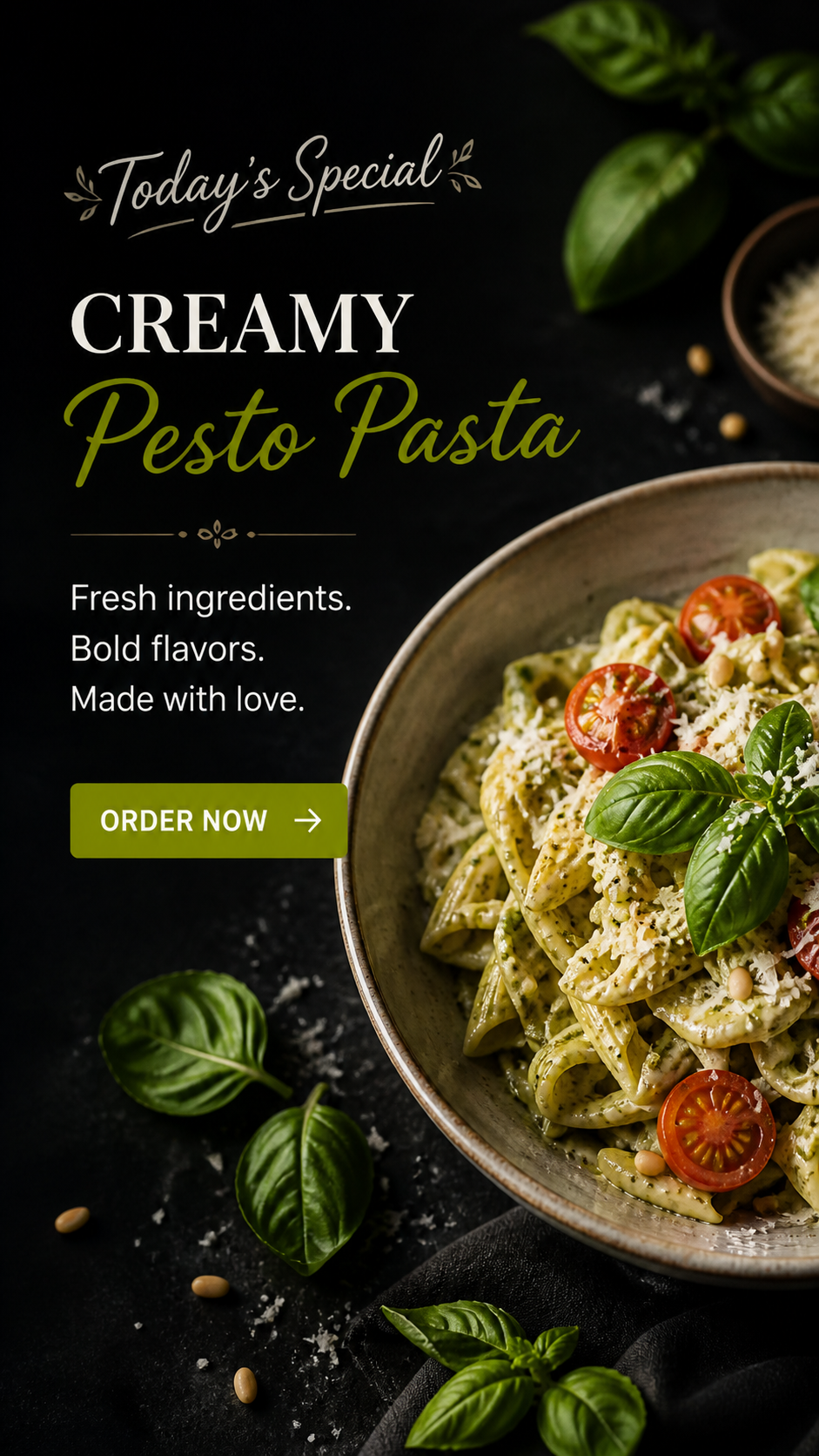 A bowl of creamy pesto pasta with cherry tomatoes and fresh basil leaves on top, surrounded by basil leaves and pine nuts on a dark surface.