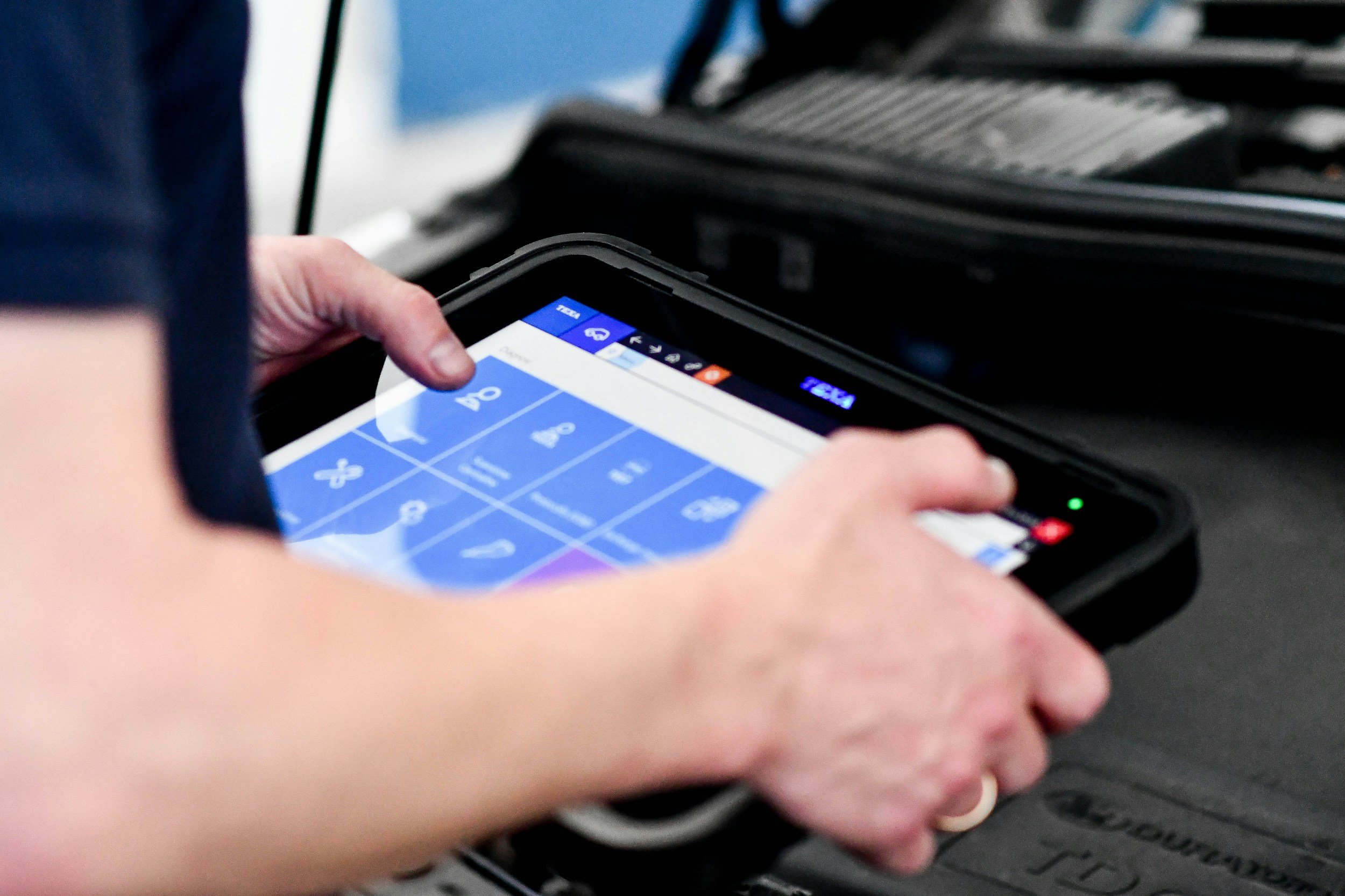 Person using a mobile device to scan or pay with a digital wallet at checkout.