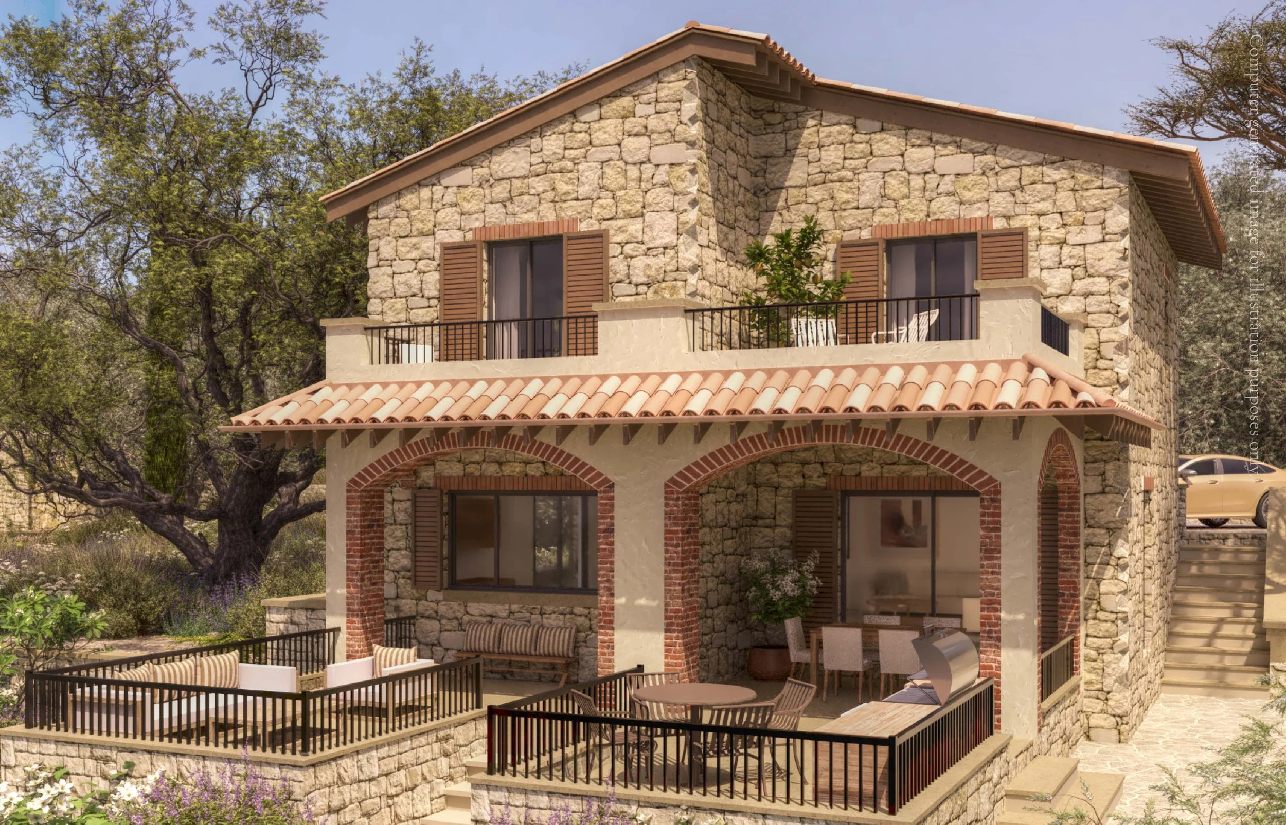 A two-story house with stone and stucco walls, terracotta roof tiles, and wooden shuttered windows. The upper level features a balcony with a small table and chairs, overlooking a patio with outdoor seating, surrounded by trees and greenery.