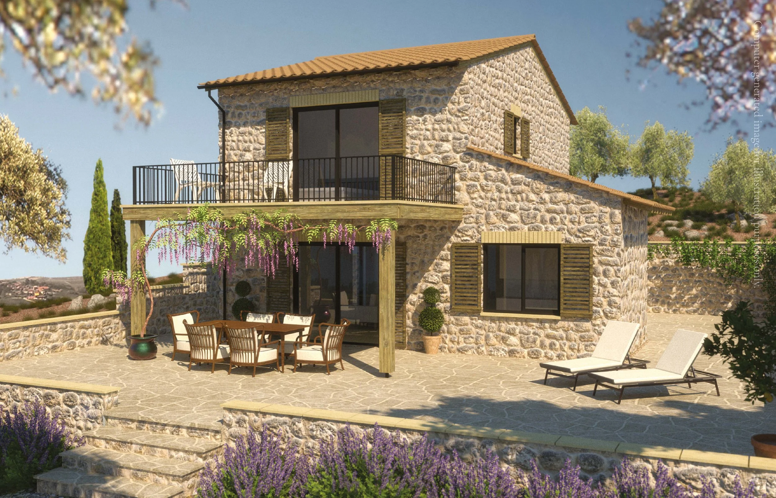 A stone house with a terracotta tile roof, featuring a balcony with chairs and a table, surrounded by trees, flowering plants, and an outdoor dining area with chairs and lounge chairs on a stone patio.