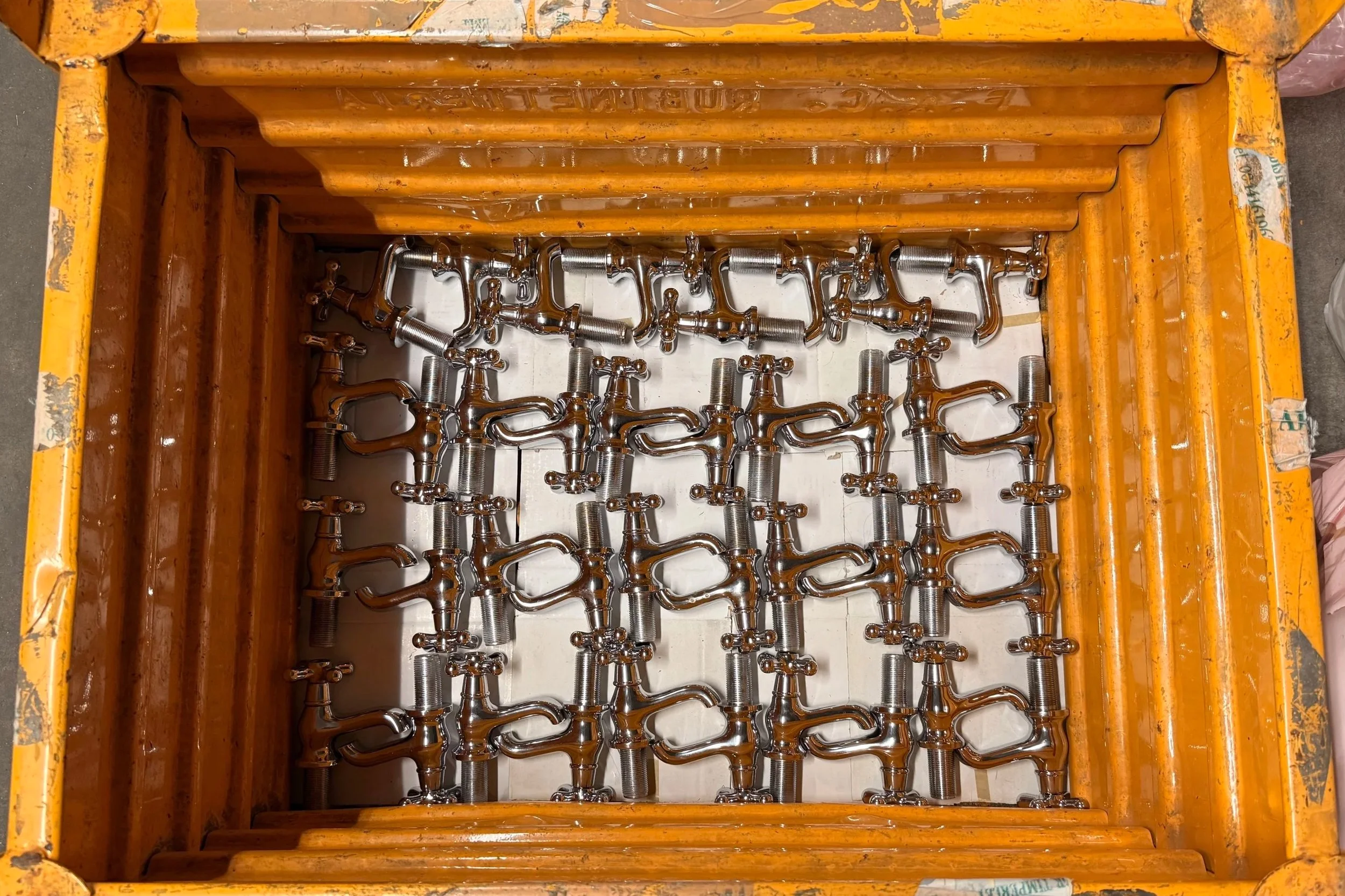 Crate full of APC Distributor Taps.