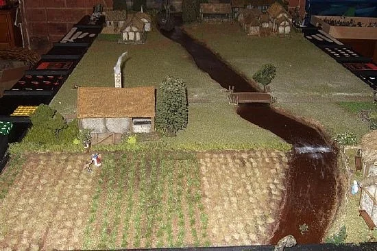 Images of wargames scenery created by John Phillips. More images can be found here http://studiotomahawk.freeforums.org/the-devil-is-in-the-detail-t4653.html

John has used both crop strips and segments of grass strips to create superbly realistic me