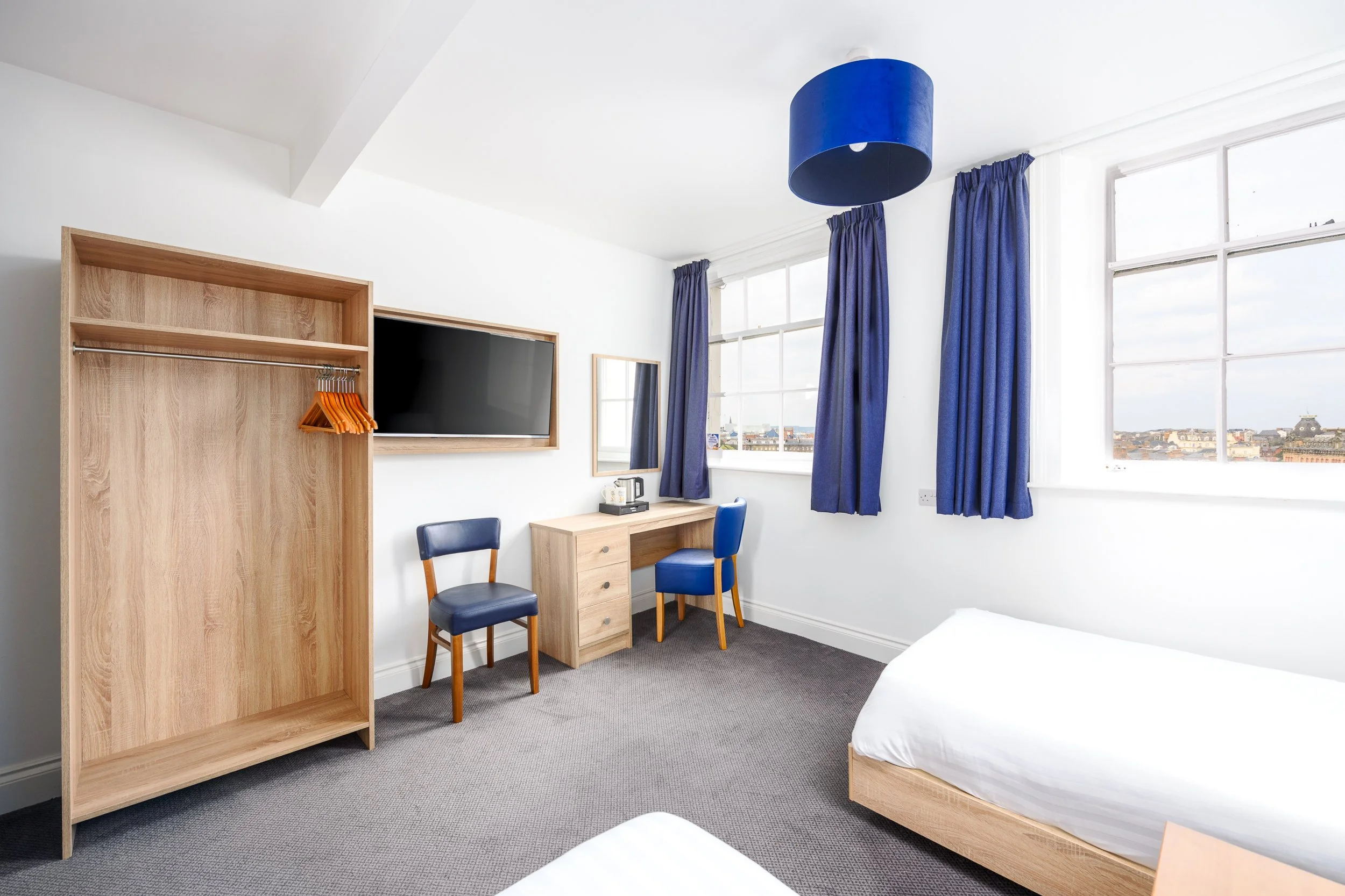 Comfortable guest bedroom at the Esplanade Hotel in Scarborough with coastal accommodation styling.