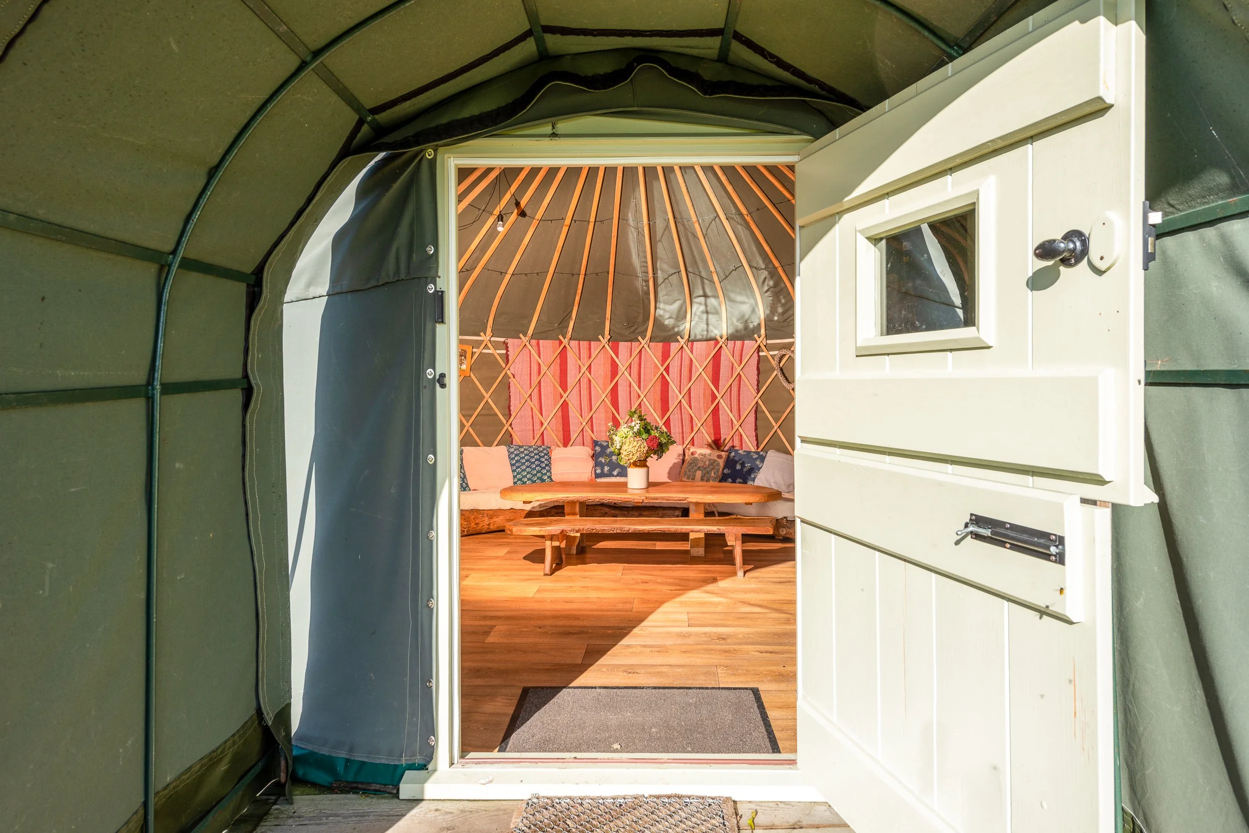 Entrance to a glamping yurt at Stock Gaylard, showing the doorway and interior beyond.