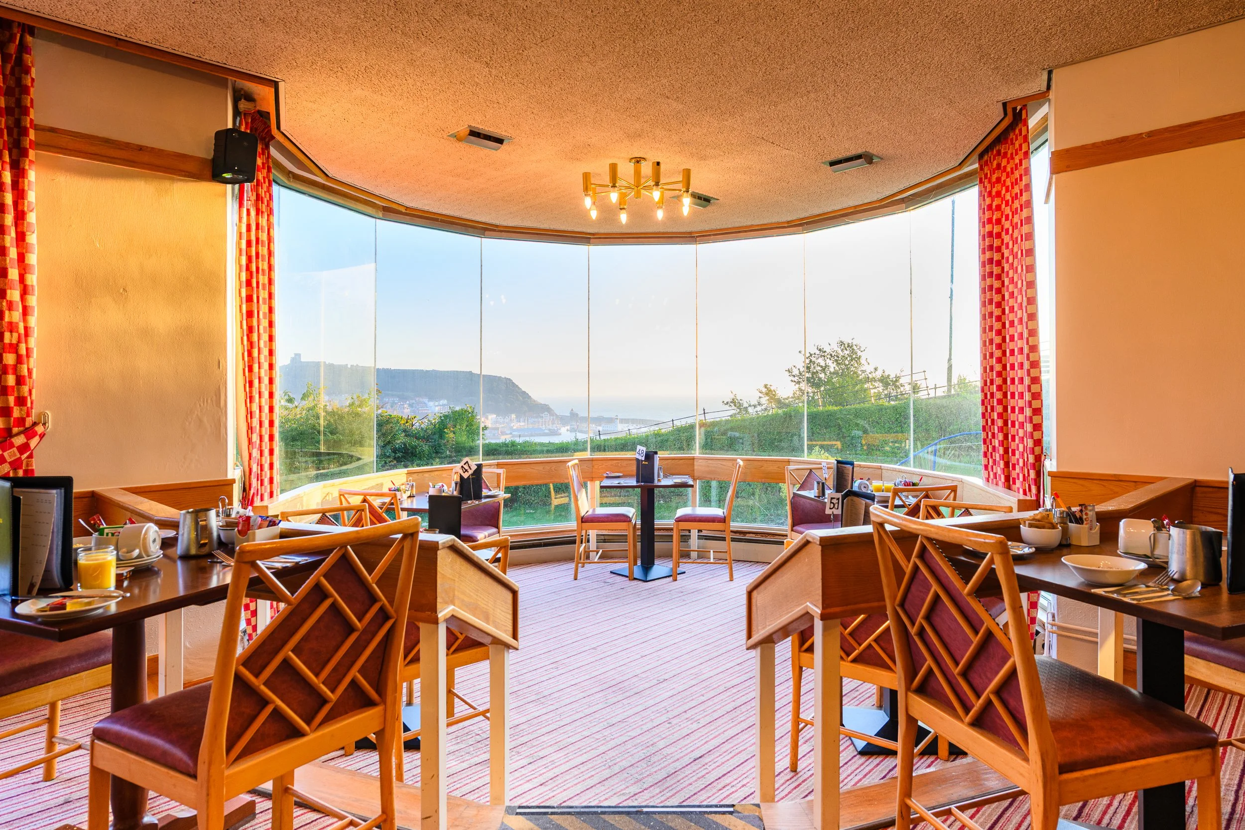 Dining space at the Esplanade Hotel overlooking Scarborough's coastline and harbour.