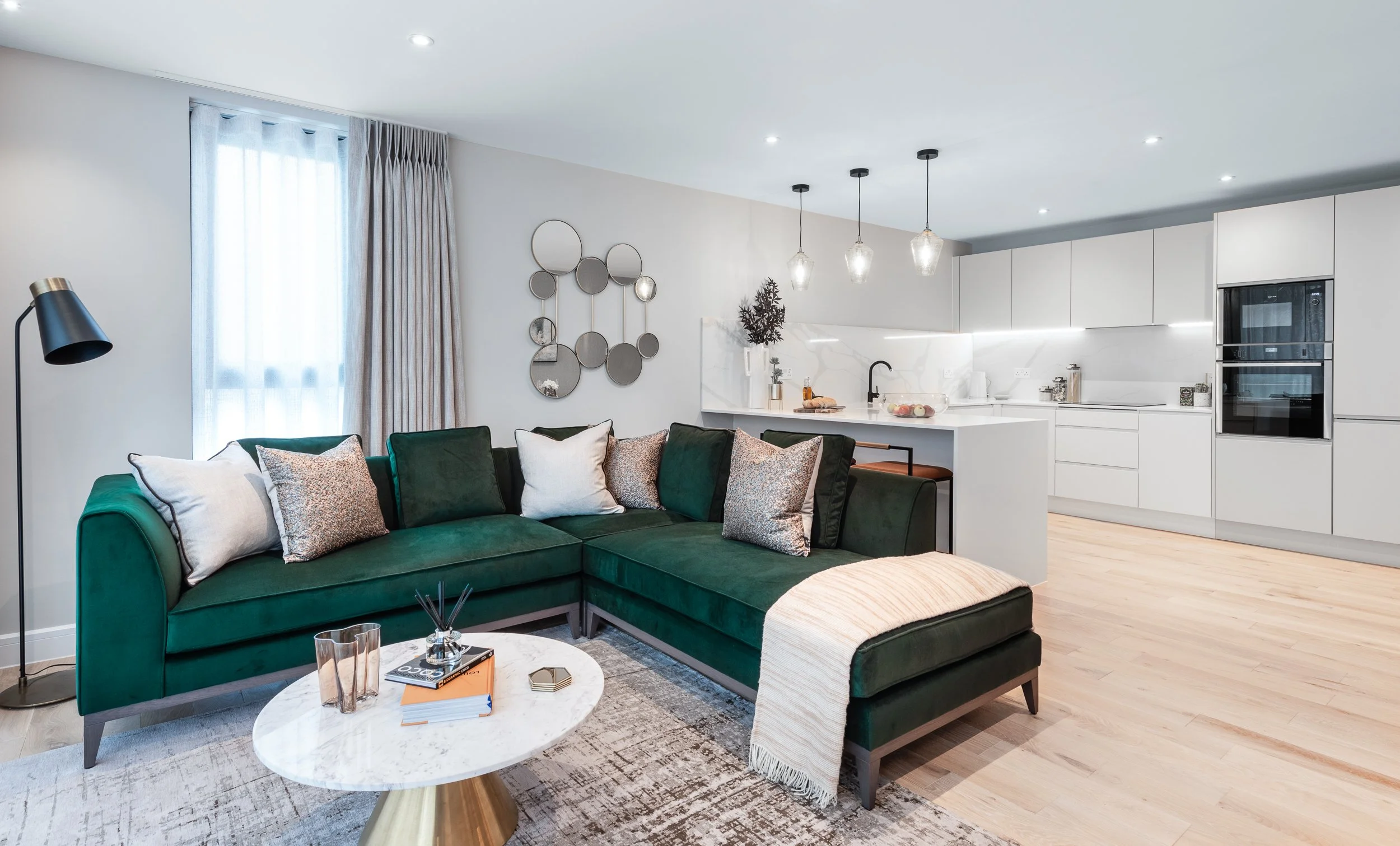 Contemporary open plan apartment featuring lounge, dining area, kitchen and coordinated interior styling.