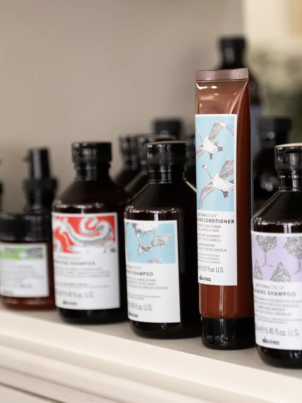 Davines Naturaltech professional shampoos and conditioners displayed at Albert Fields hair salon in Goring-on-Thames.