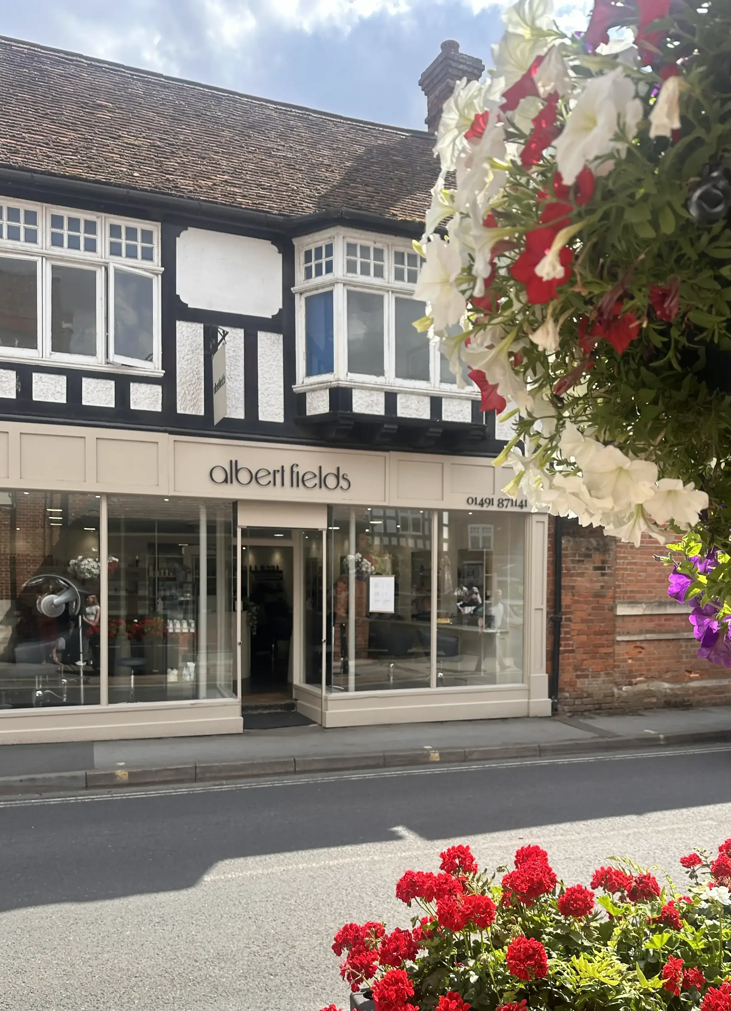 Albert Fields hair salon in Goring-on-Thames, welcoming frontage with flowers and large glass windows