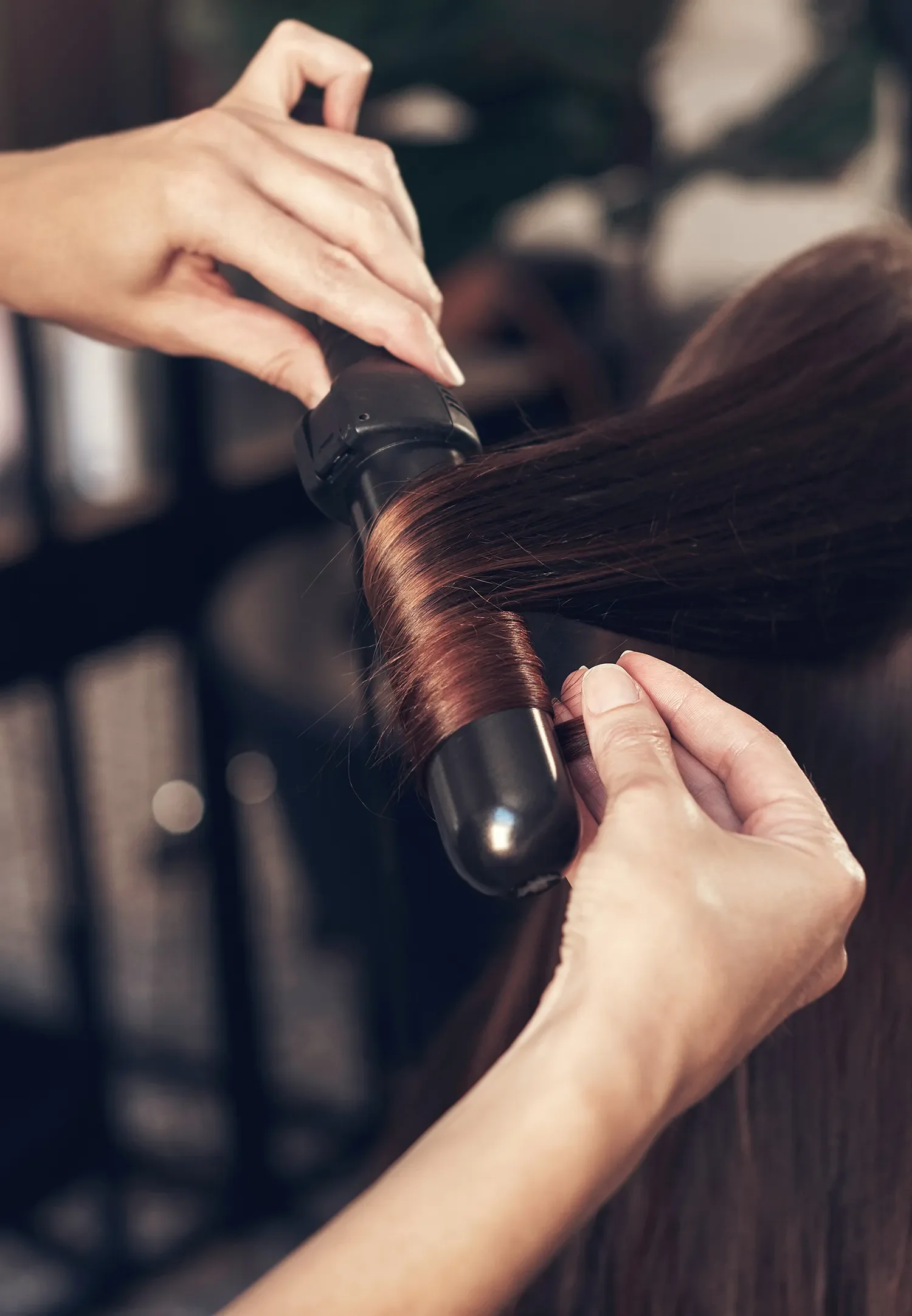 Stylist curling ladies hair at Albert Fields near Reading, Berkshire
