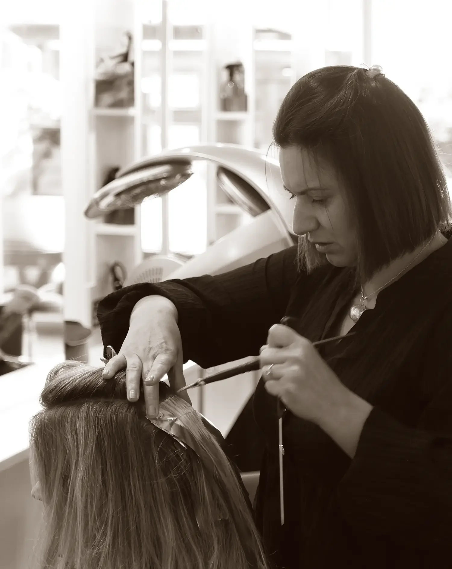 Hairdresser applying Davines hair colour with foils at Albert Fields boutique salon in Goring-on-Thames