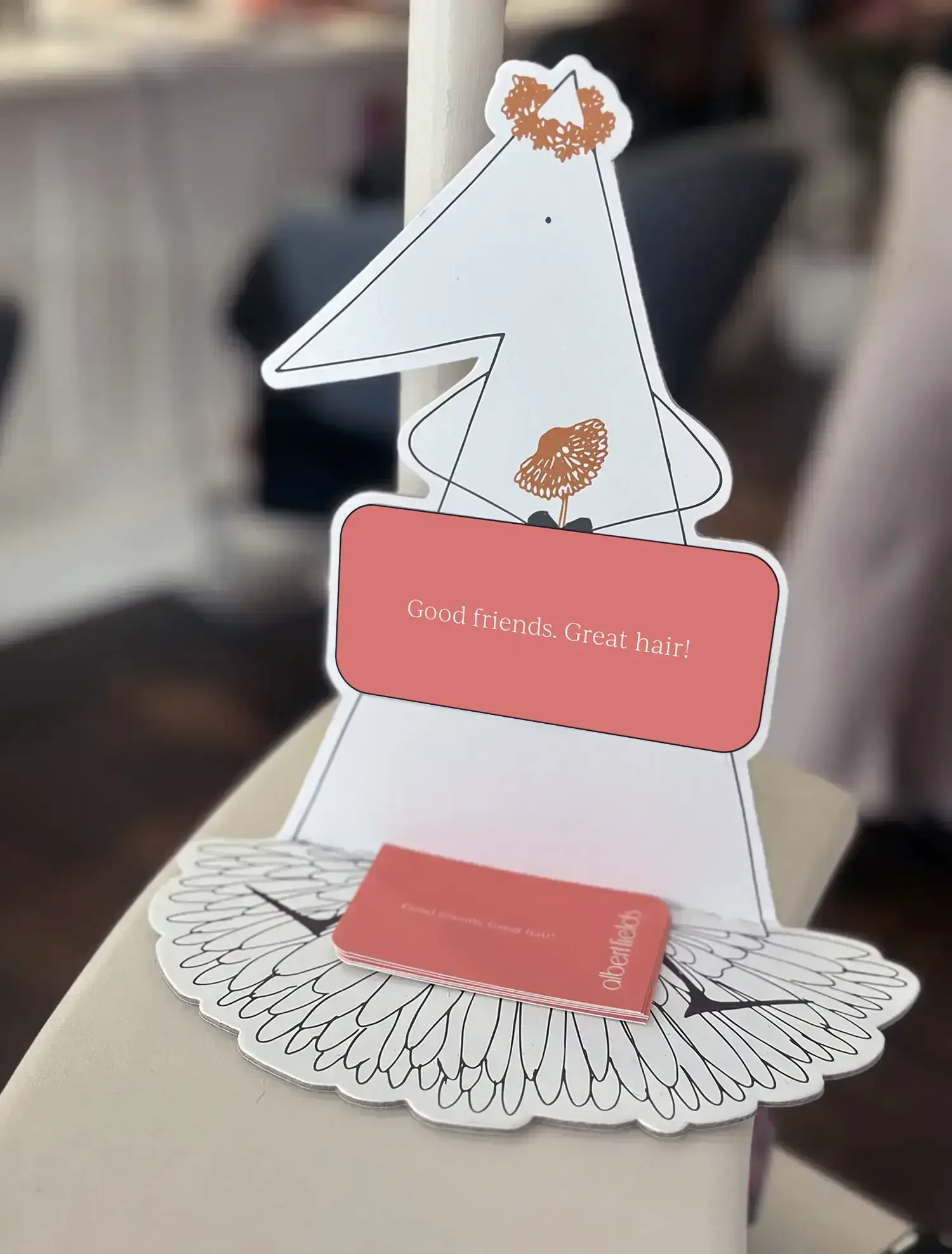 Albert Fields salon display with cards reading ‘Good friends. Great hair!’ inside the Goring-on-Thames salon