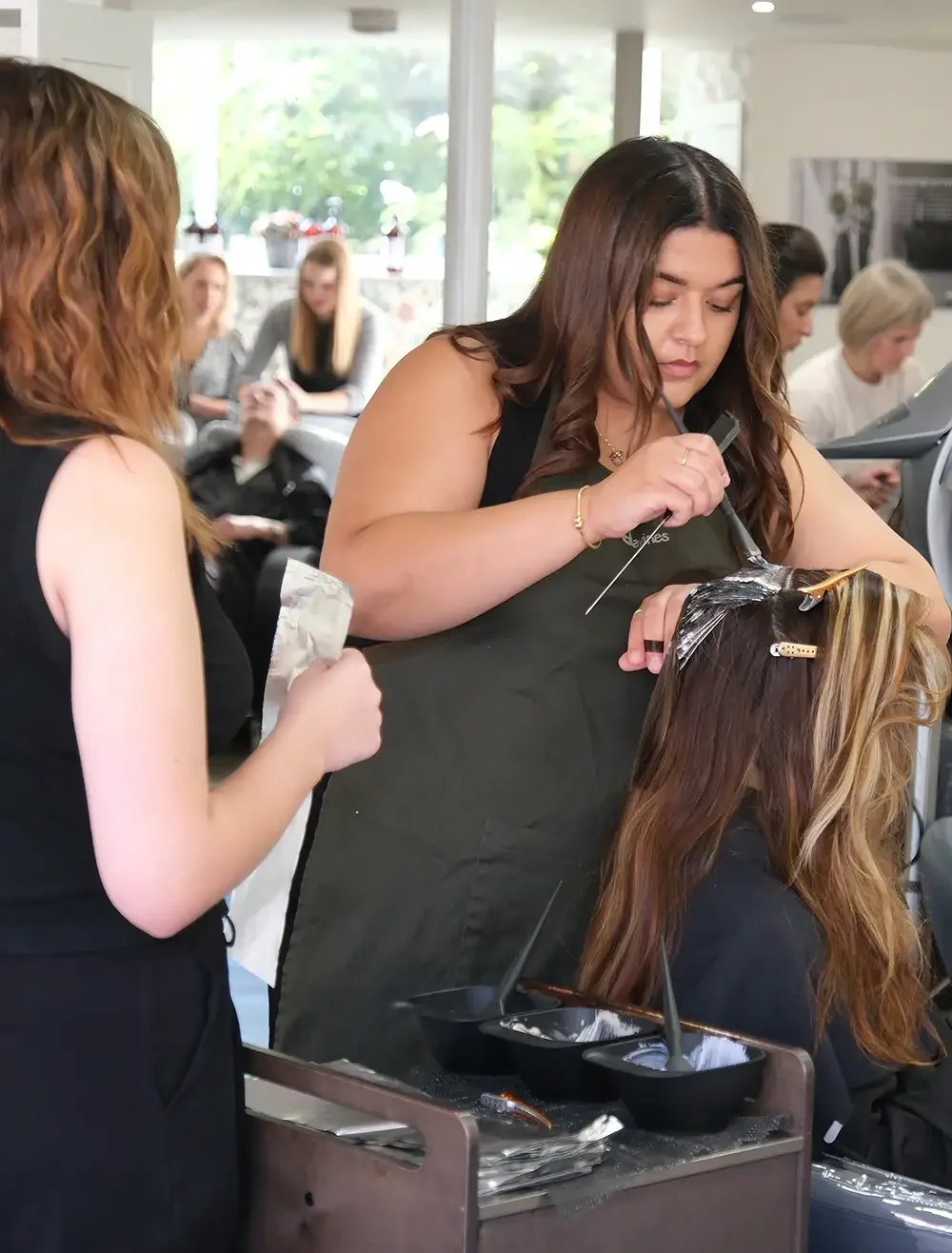Stylist applying bespoke highlights with foils at Albert Fields hair salon in Goring-on-Thames, creating a natural blended look